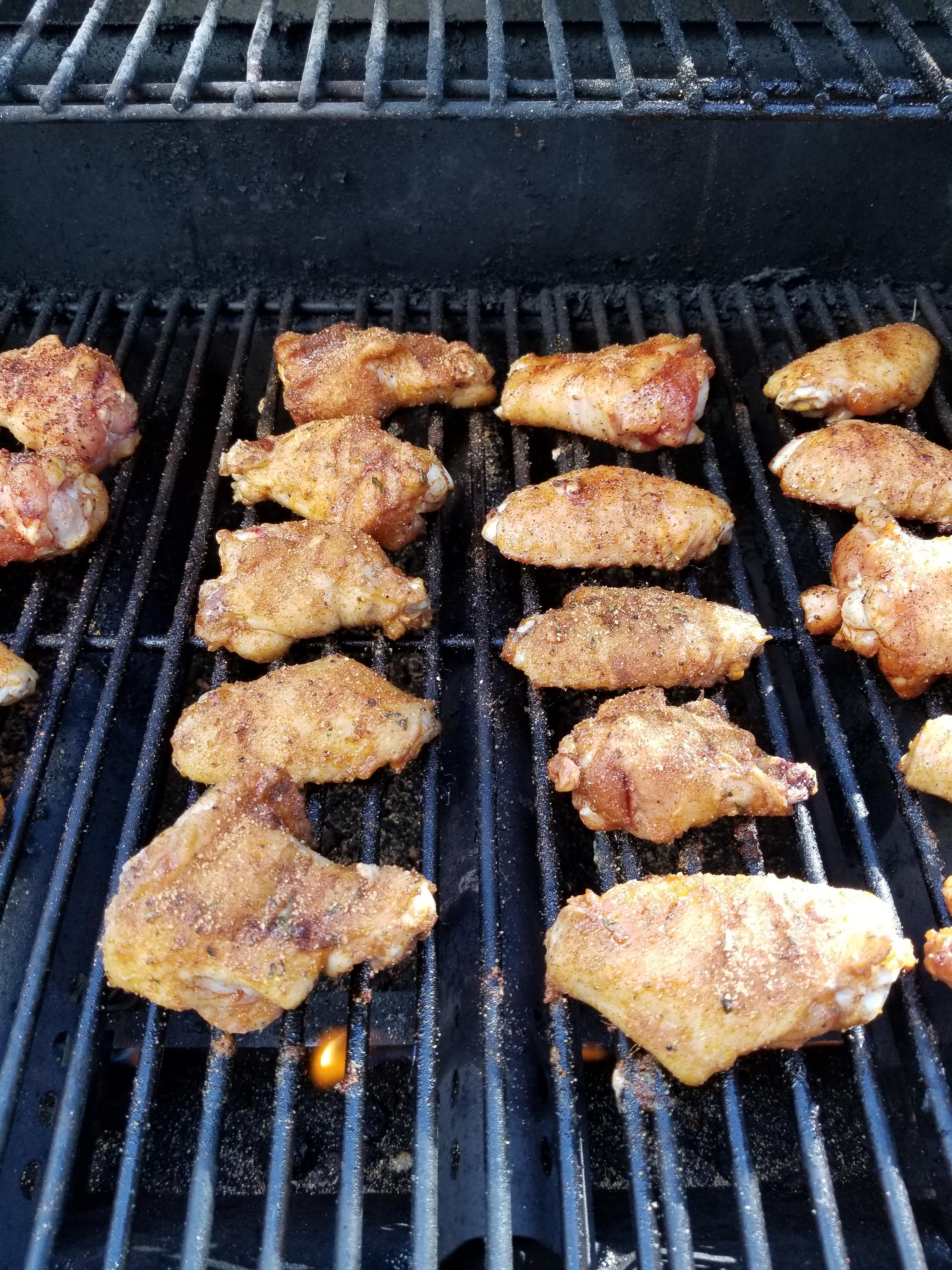 Grilled wings, some with meat church Voodoo, some with Honey bacon, and