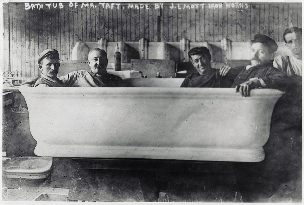1909. Four plumbers model the new bathtub for newly elected President