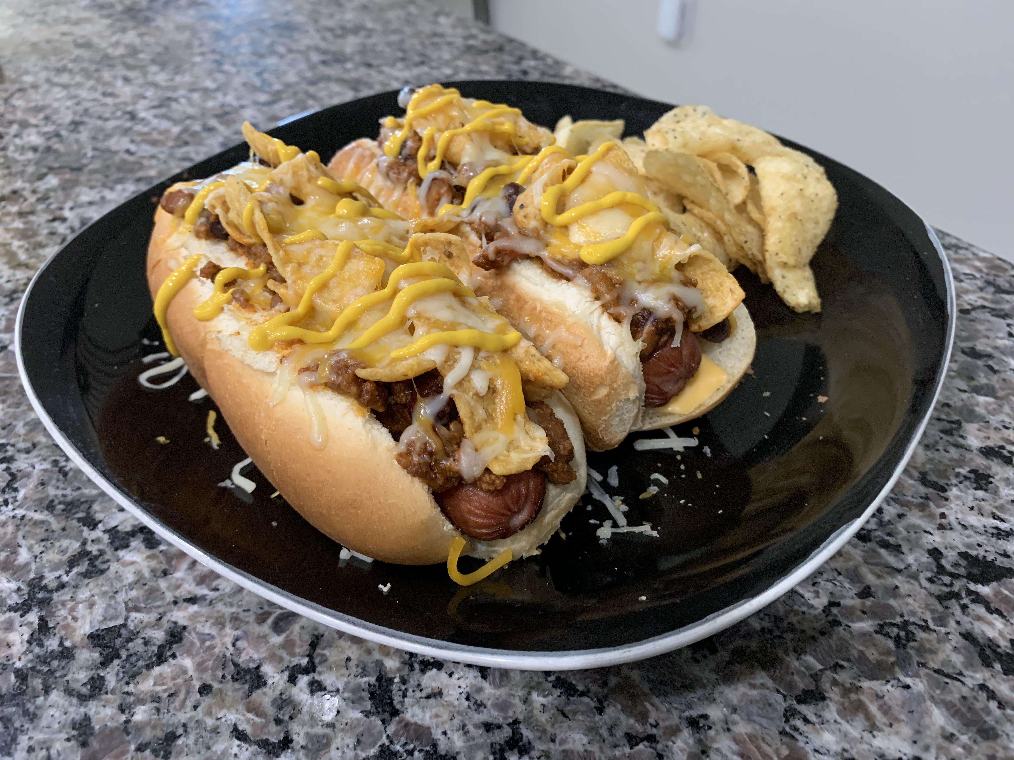 Frito Pie Dogs (jumbo Nathan’s with homemade chili, cheese, Fritos, and