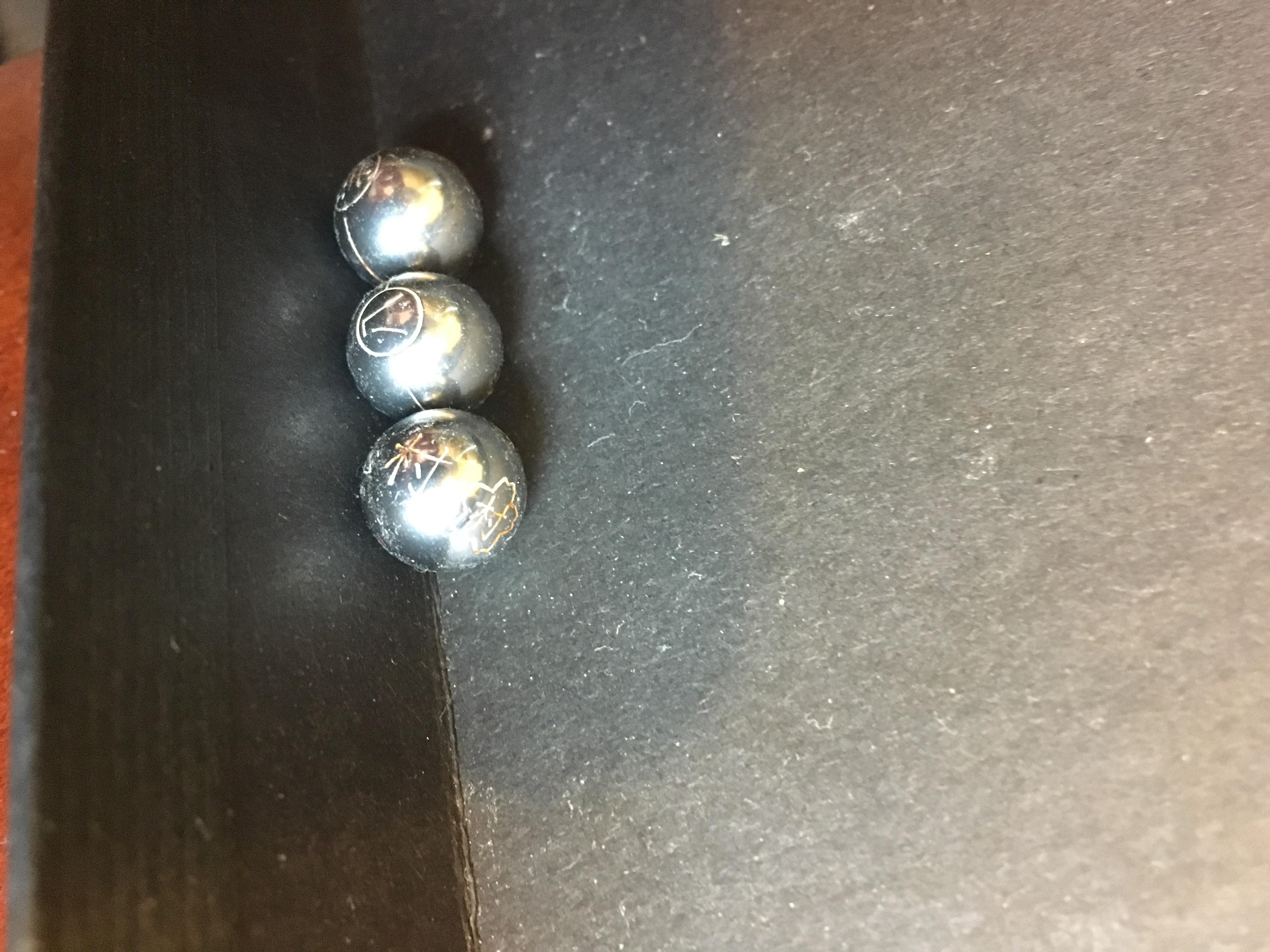 3 Metal marbles with Asian writing on them. Found together in the back