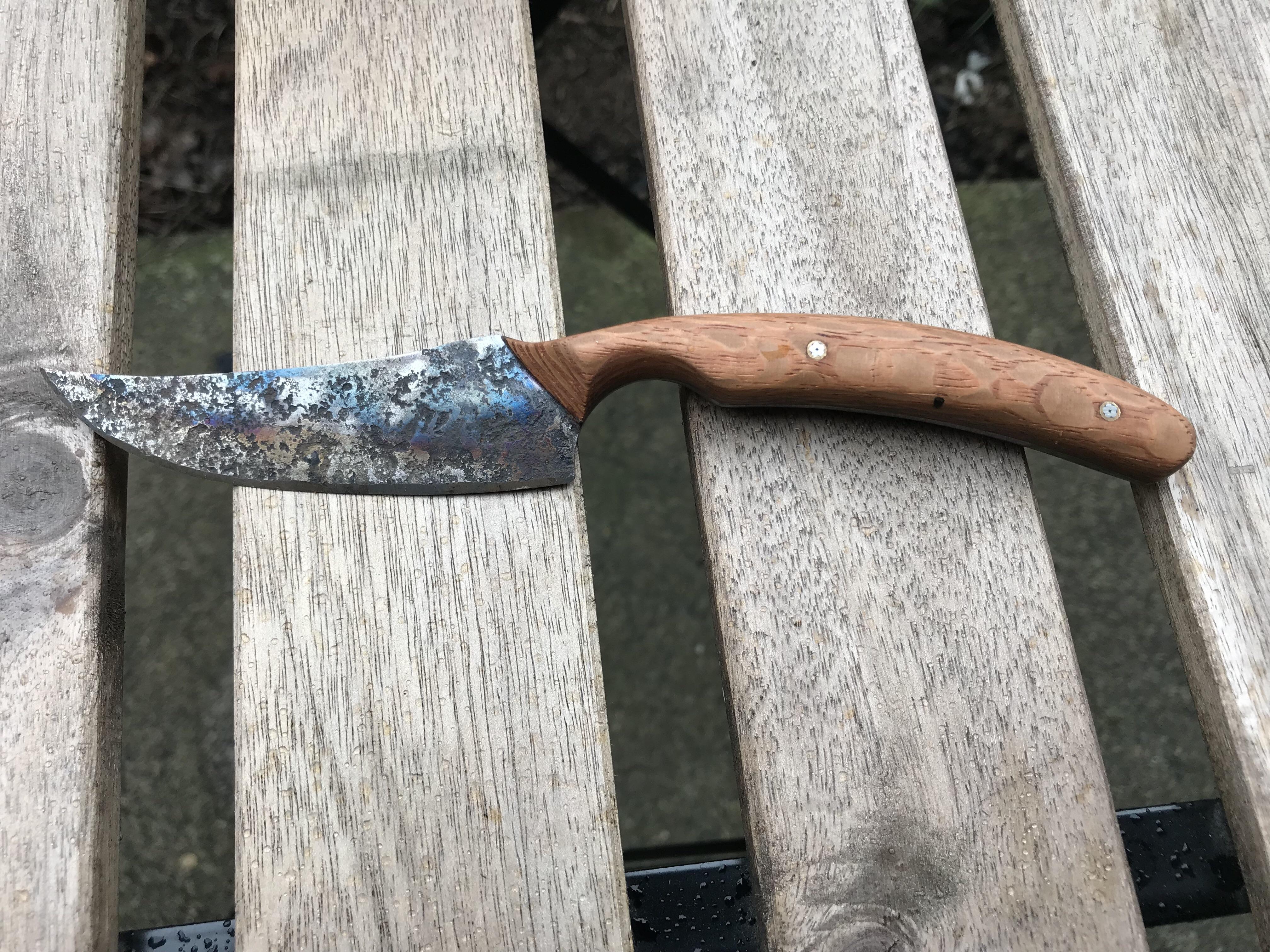 Hand blade with tempering patina. Hand cut and finished scales