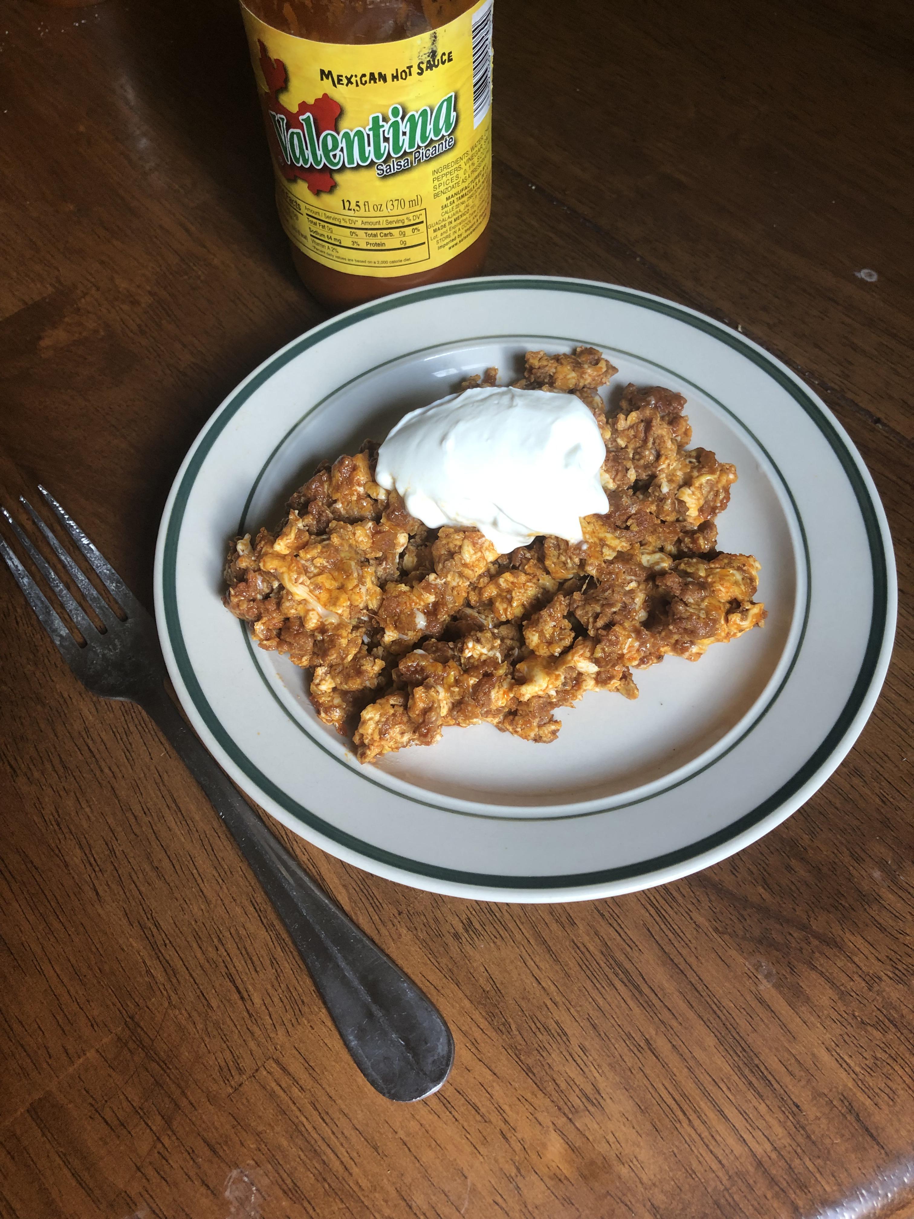 A rekindled love. Chorizo and eggs with sour cream and hot sauce. r