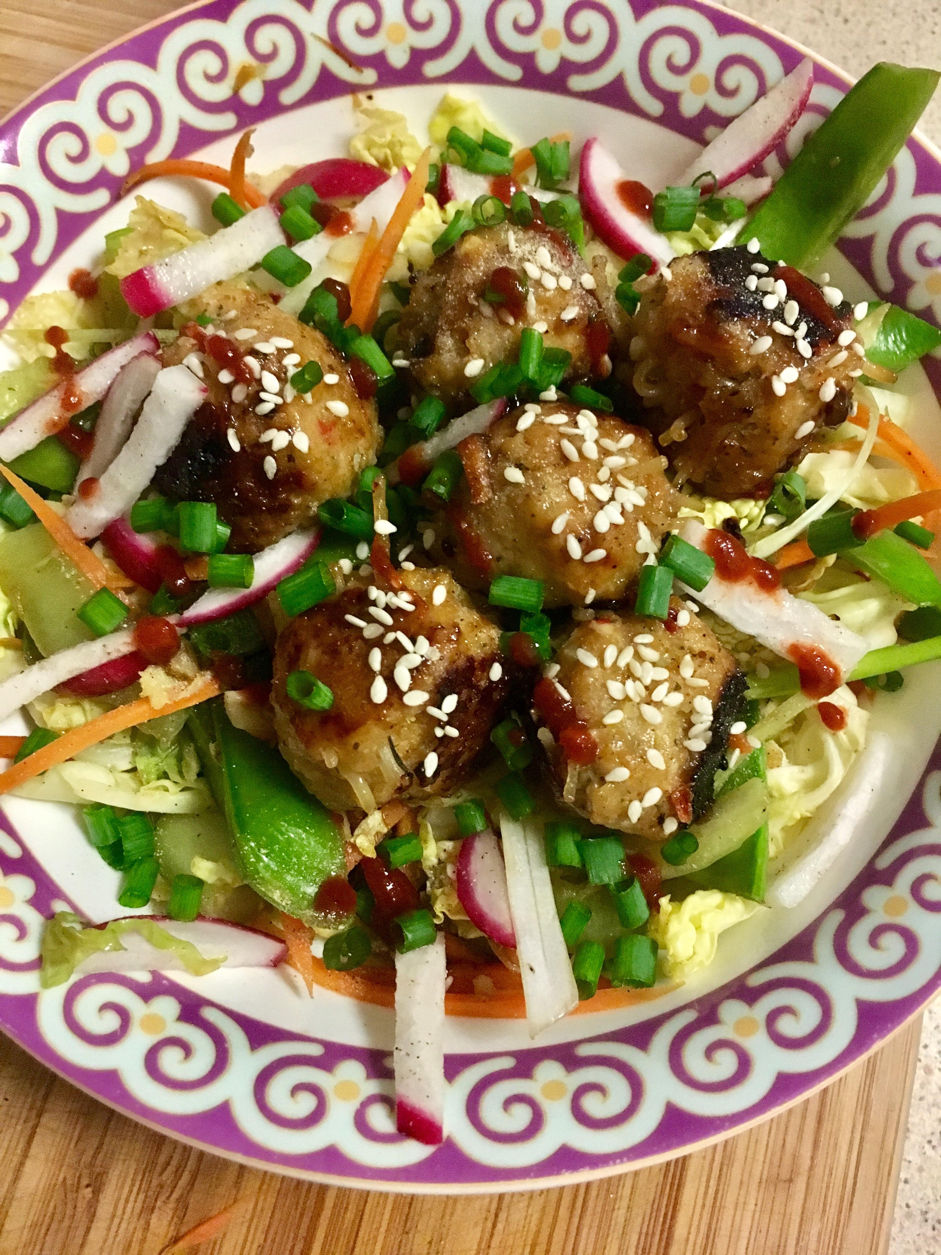 Dinner Asian chicken meatballs with stir fried vegetables in honey