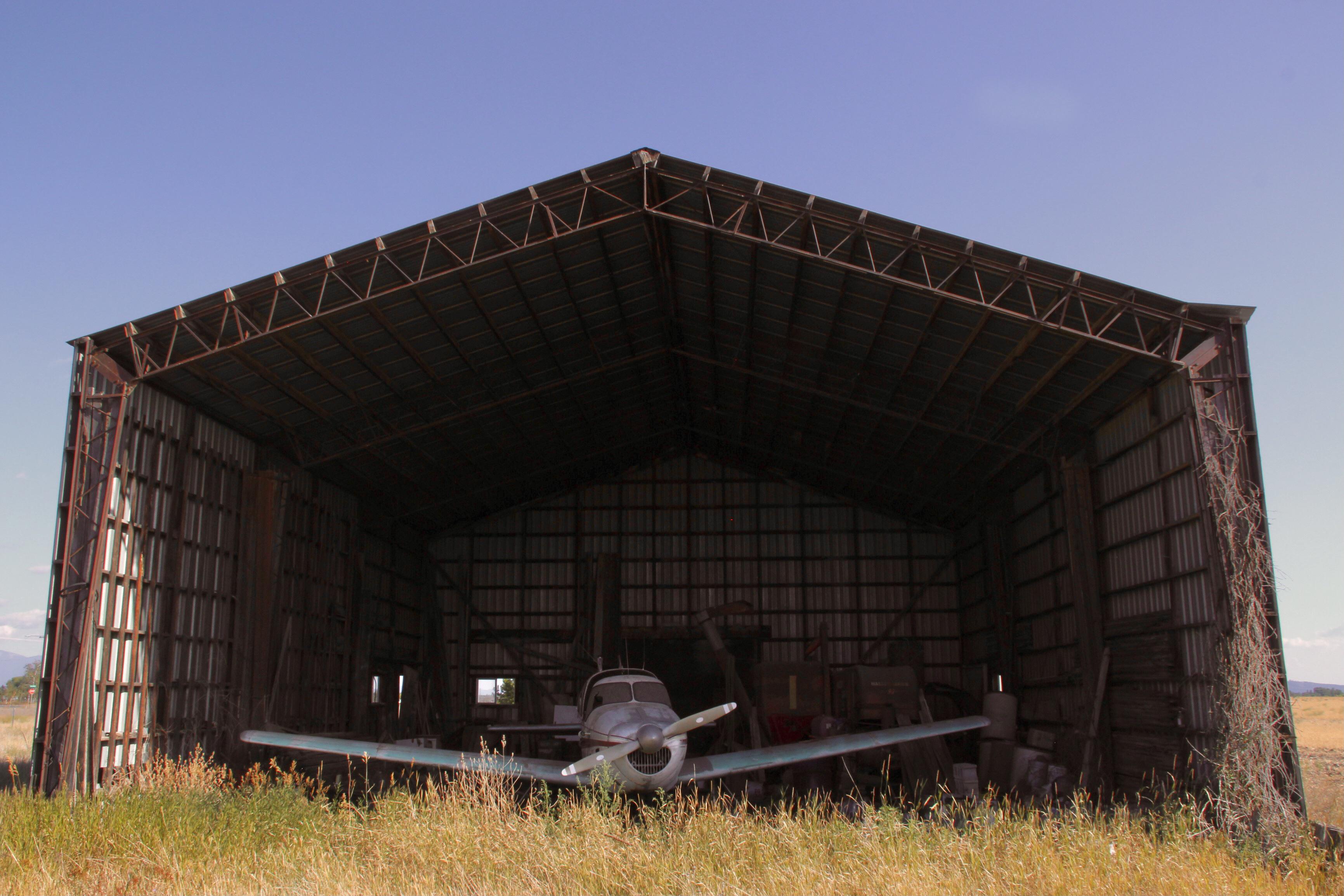 Abandoned hangar and aircraft at what used to be an airstrip, before it