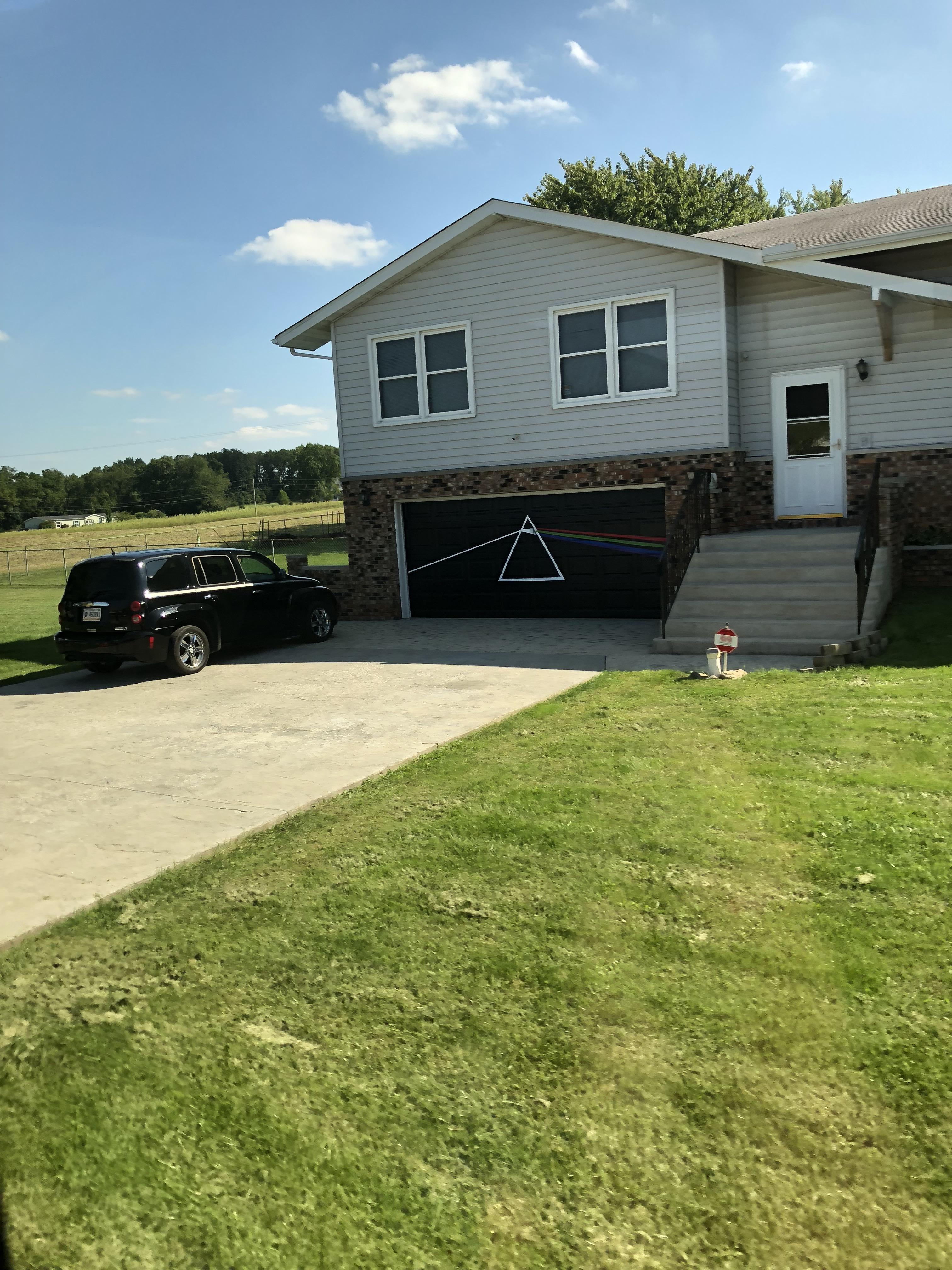 My neighbor painted their garage door as DSOTM. r/pinkfloyd