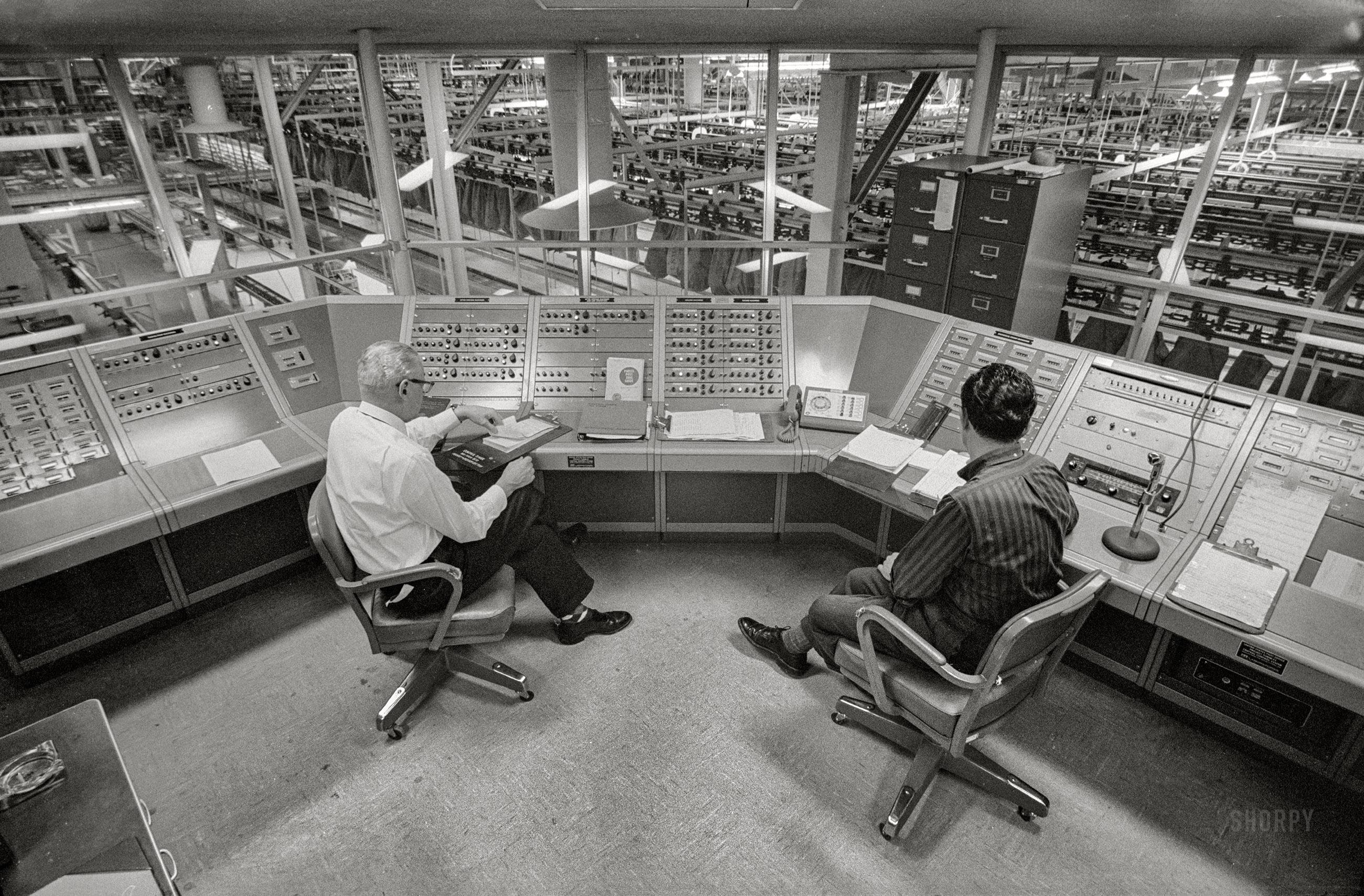 Post Office employees sitting at Central Control System overlooking