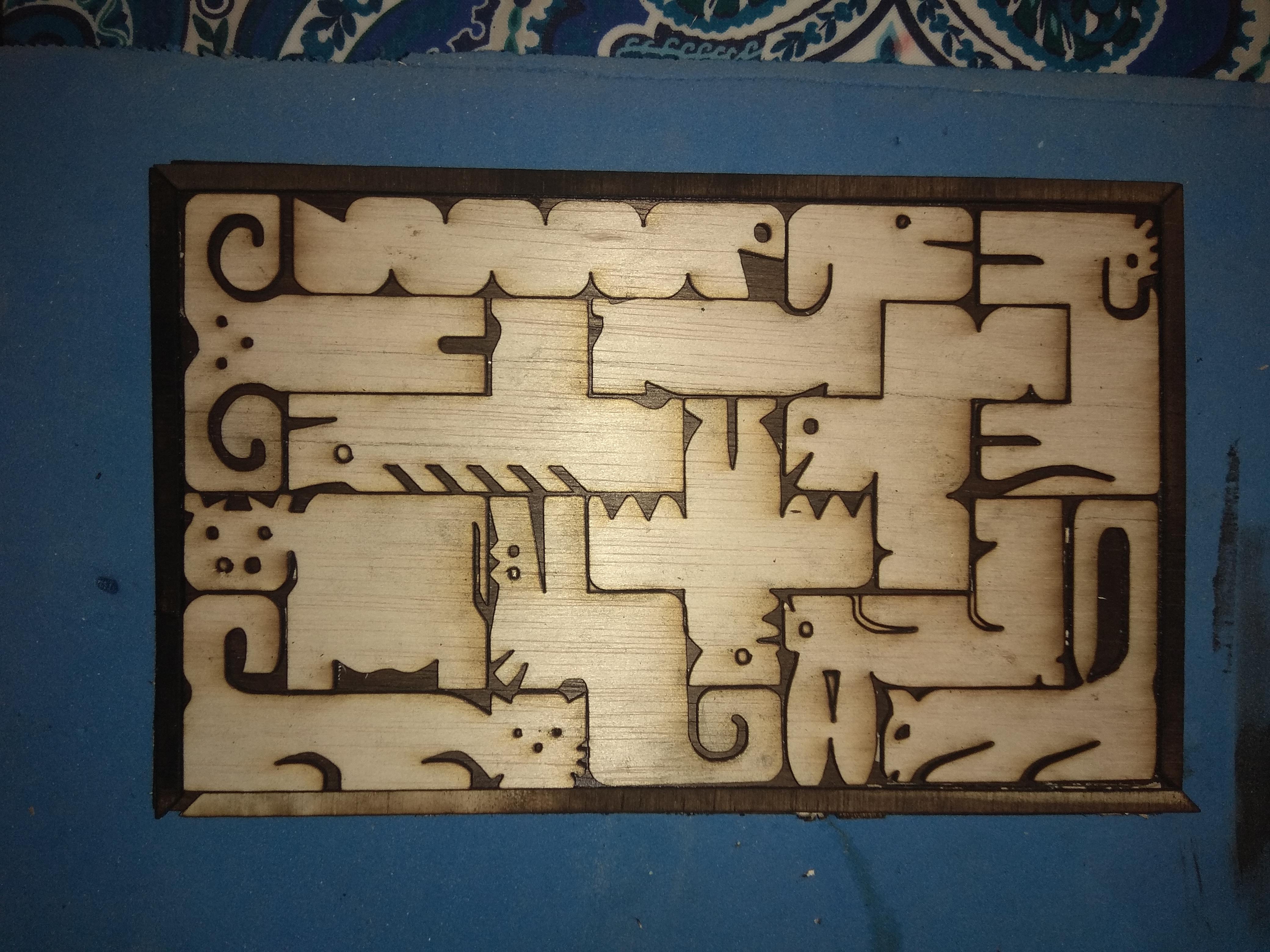 Help removing black dust from plywood I have done this puzzle with my