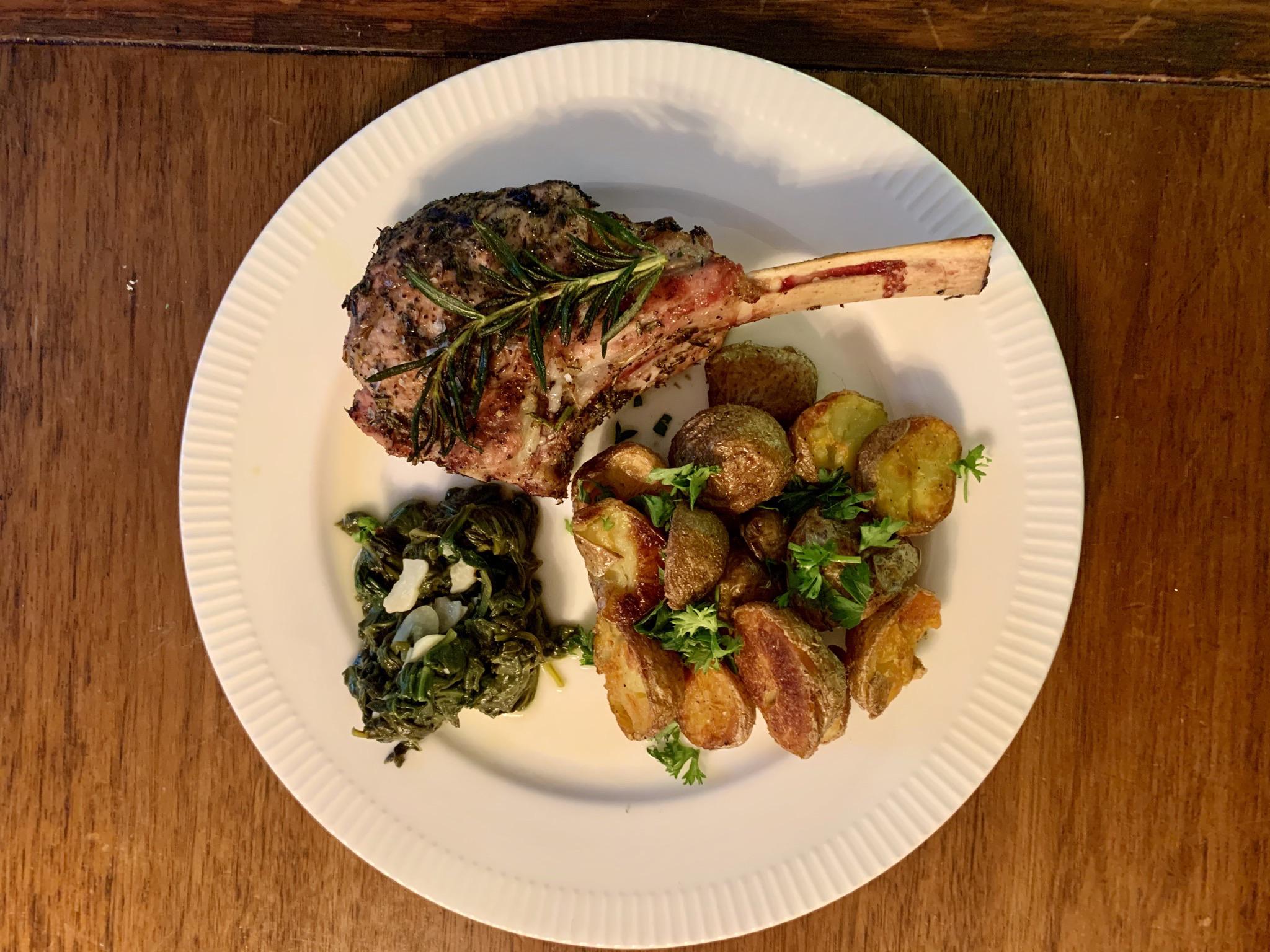 Herby veal chop with schmaltzy potatoes and sautéed spinach. r/FoodPorn