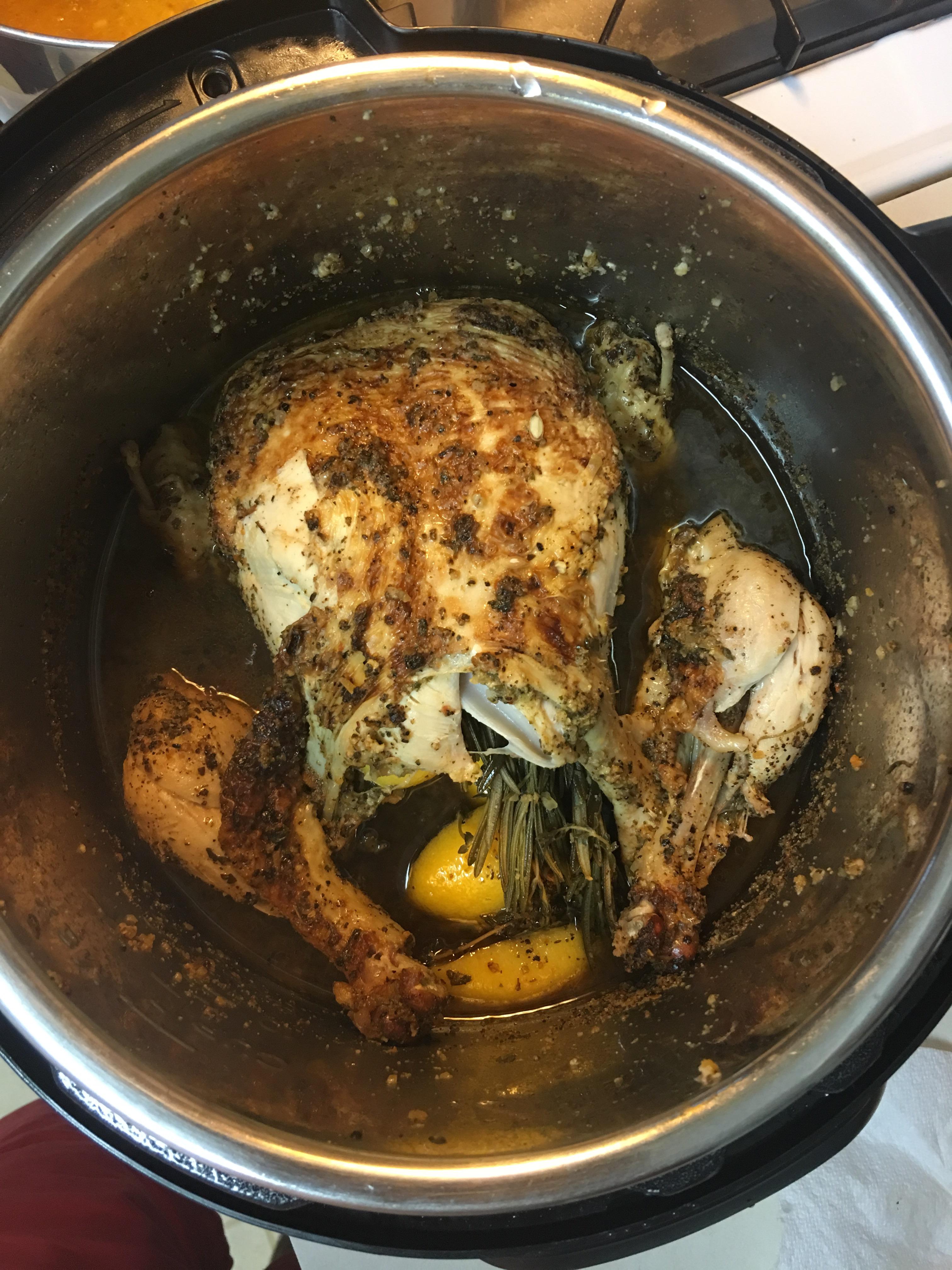 Whole chicken with spice rub, stuffed with lemon and herbs, cooked in