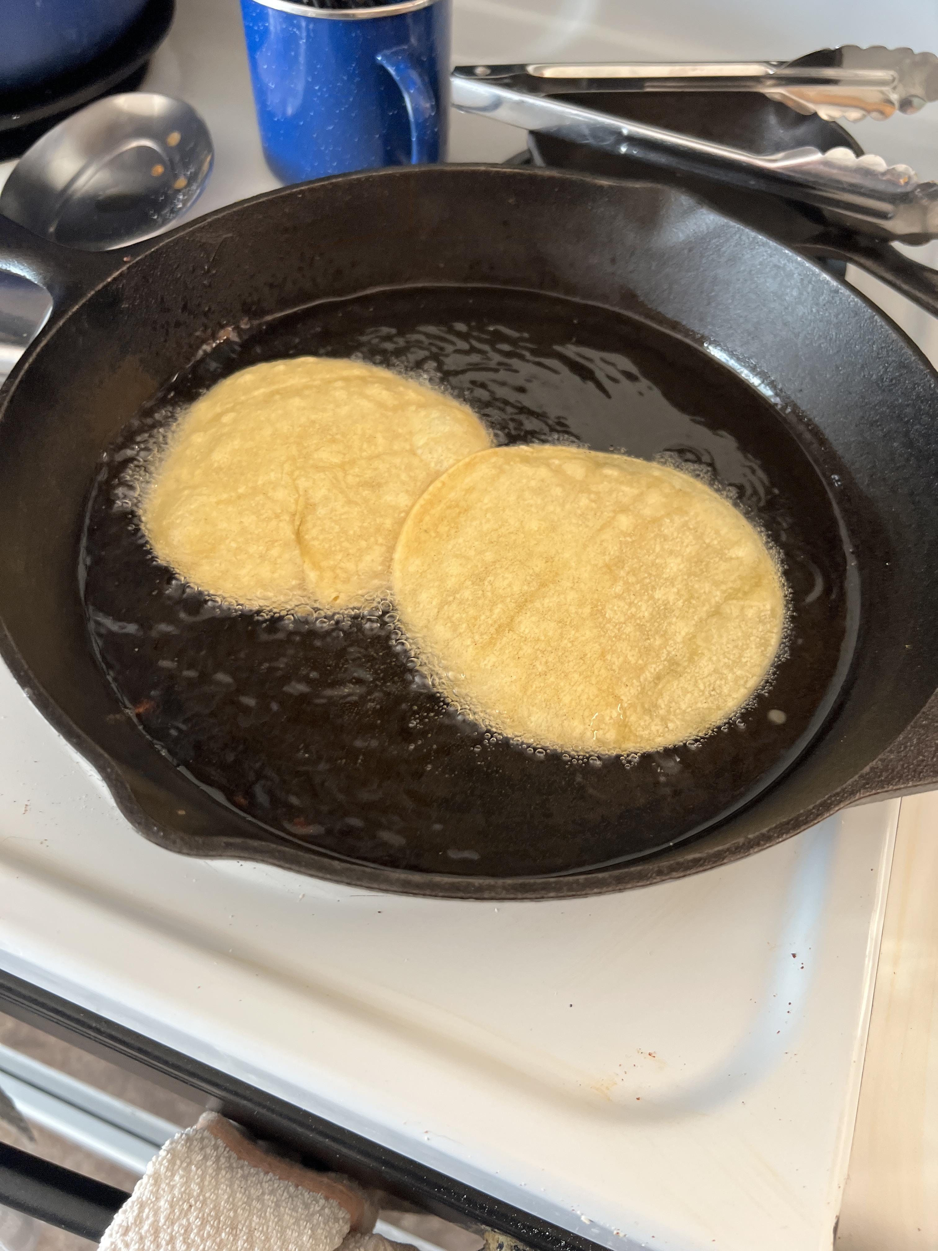 Frying corn tortillas to make enchiladas is a great way to season cast
