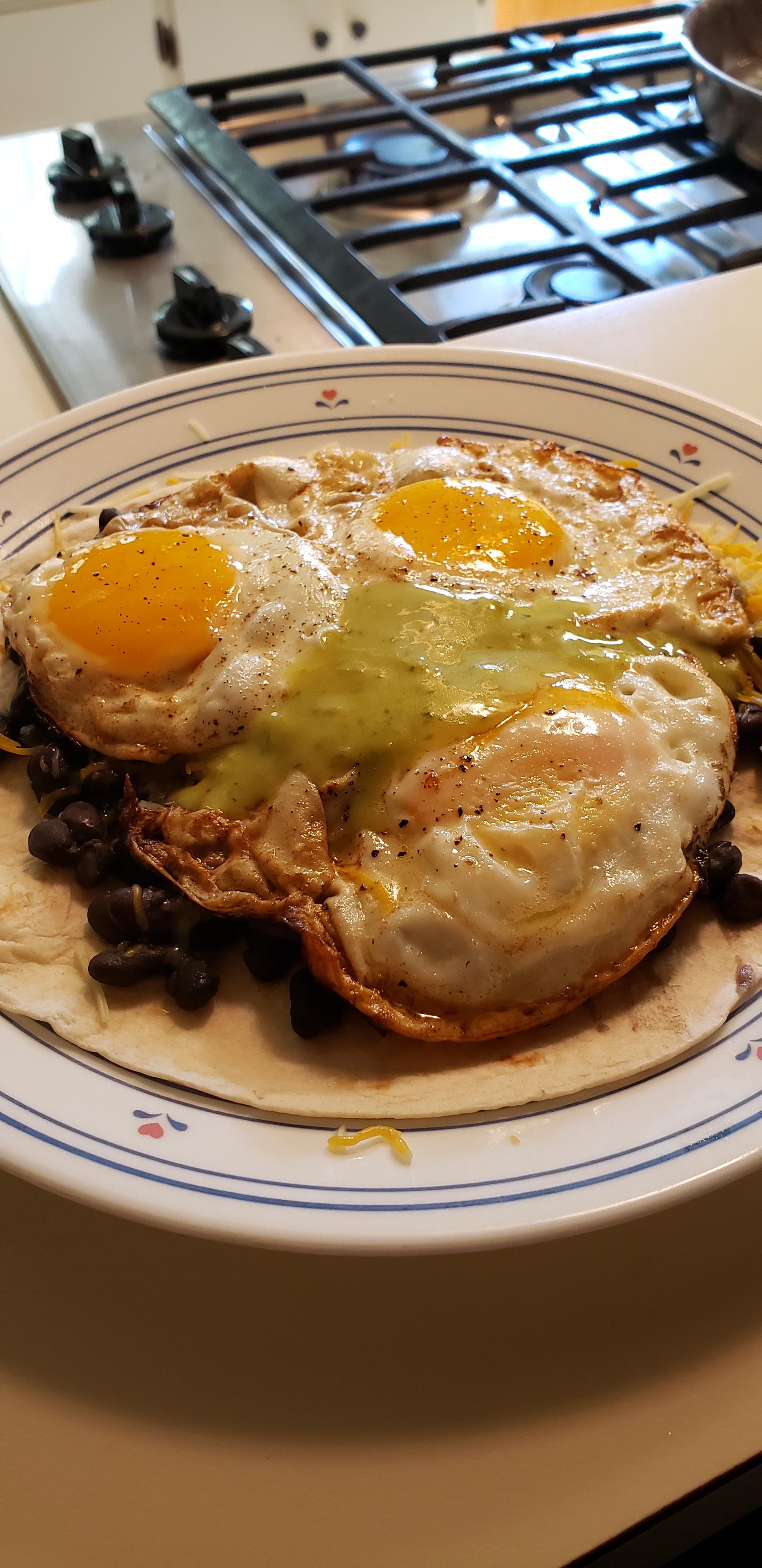[Homemade] Eggs, cheese, and beans on a flour tortilla topped with
