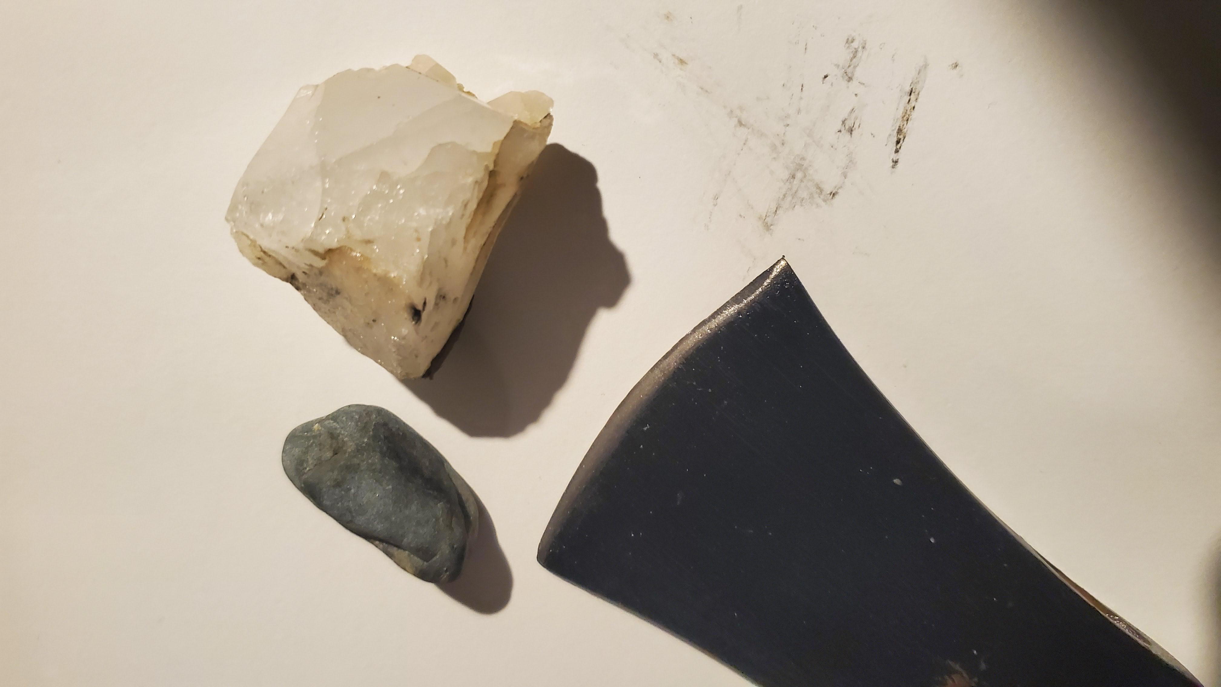 I've taken to using river stones and rough quartz rocks to sharpen