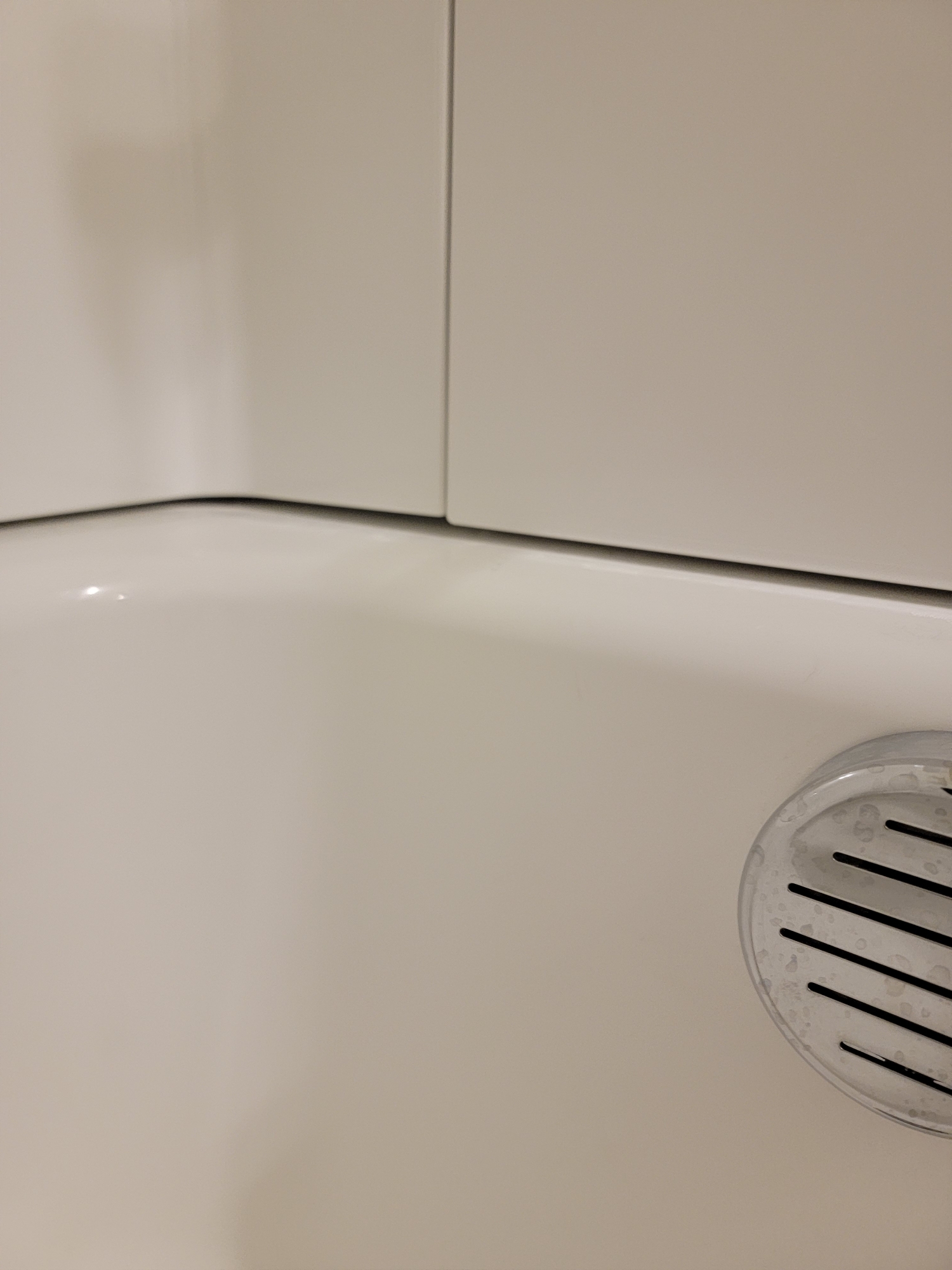 Large gaps in bathtubs of newly constructed house. Caulked one tub, and