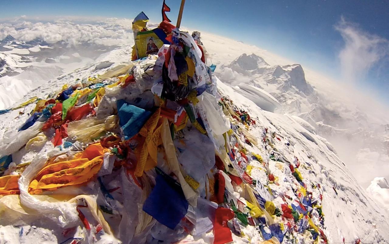 The summit of Mount Everest, littered with flags from climbers. r/pics