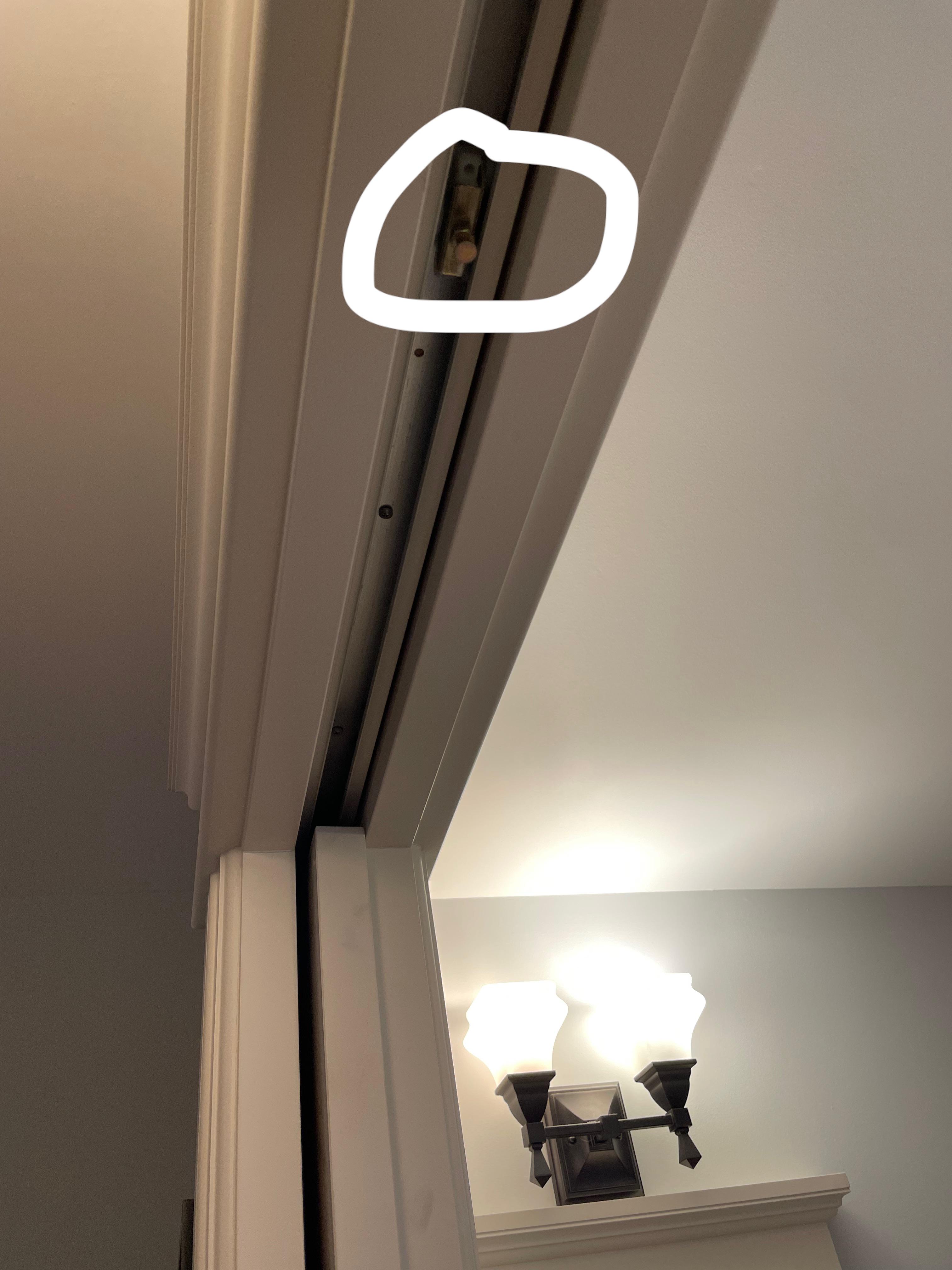 How do I get the sliding pocket door back onto the roller without