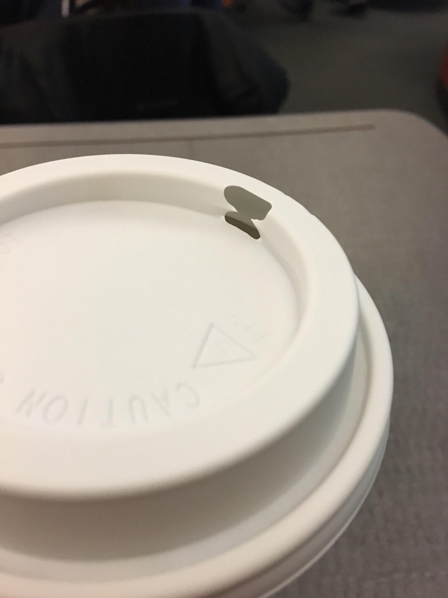The hole for my Starbucks cup lid was offcenter. r/mildlyinteresting