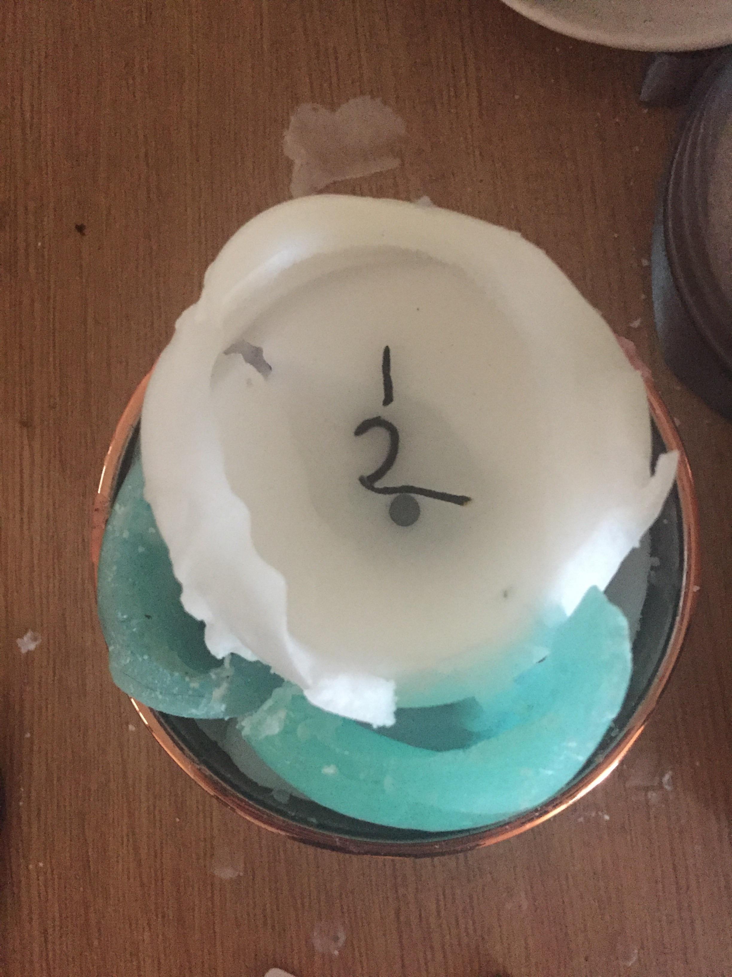 My candle wick burned into a 1 and 2 overnight. r/mildlyinteresting