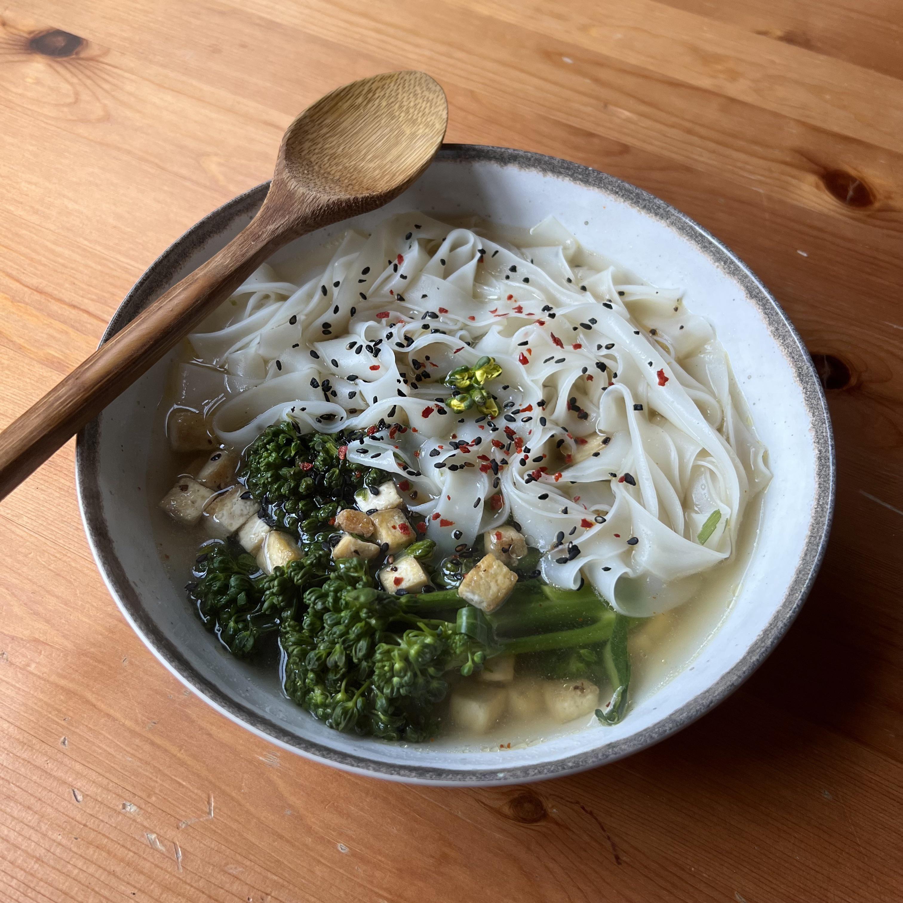 rice noodles in spicy ginger broth with tofu and broccolini fried in