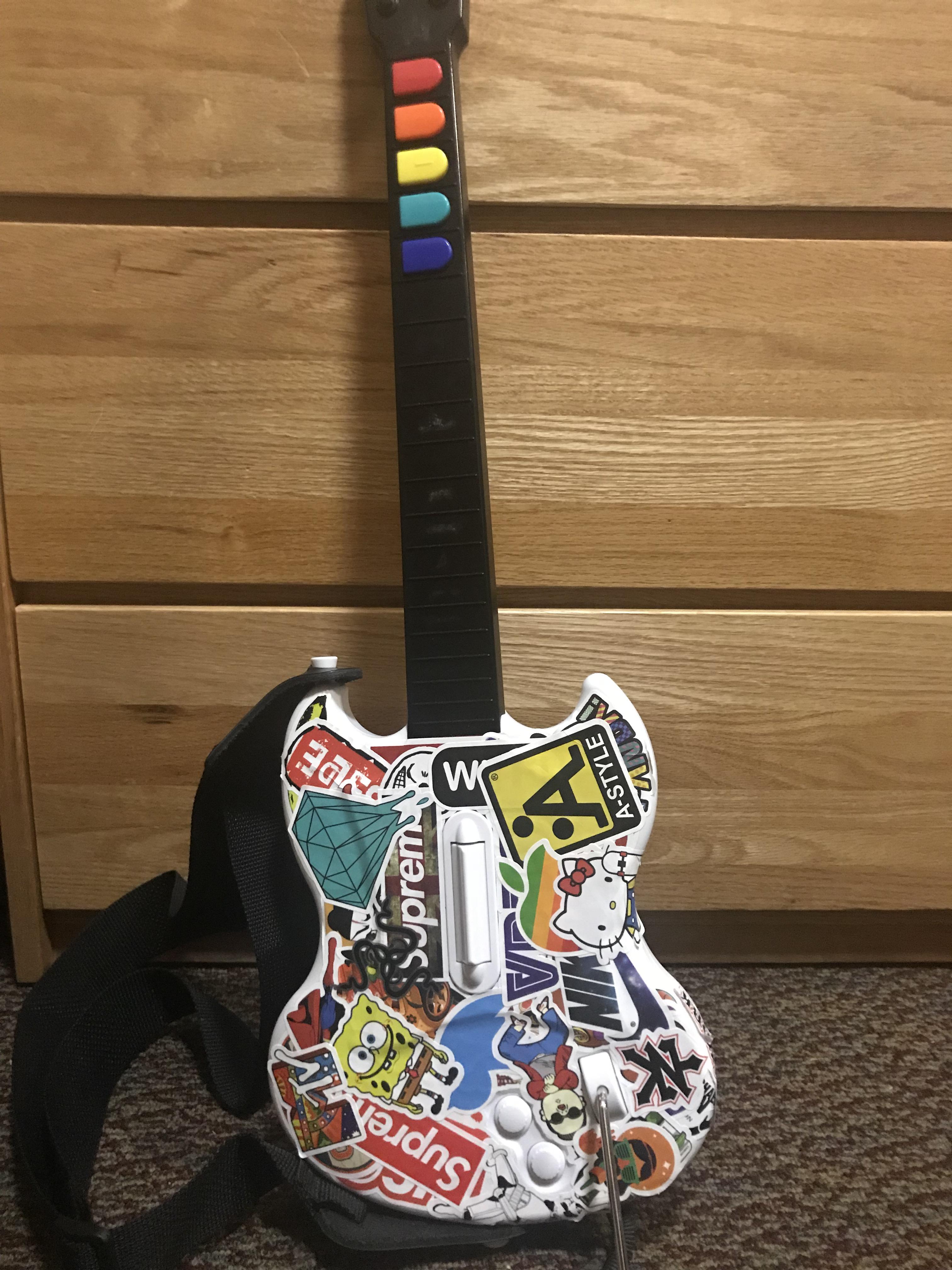 Someone said I should show you guys my guitar. Sticker bomb + rainbow
