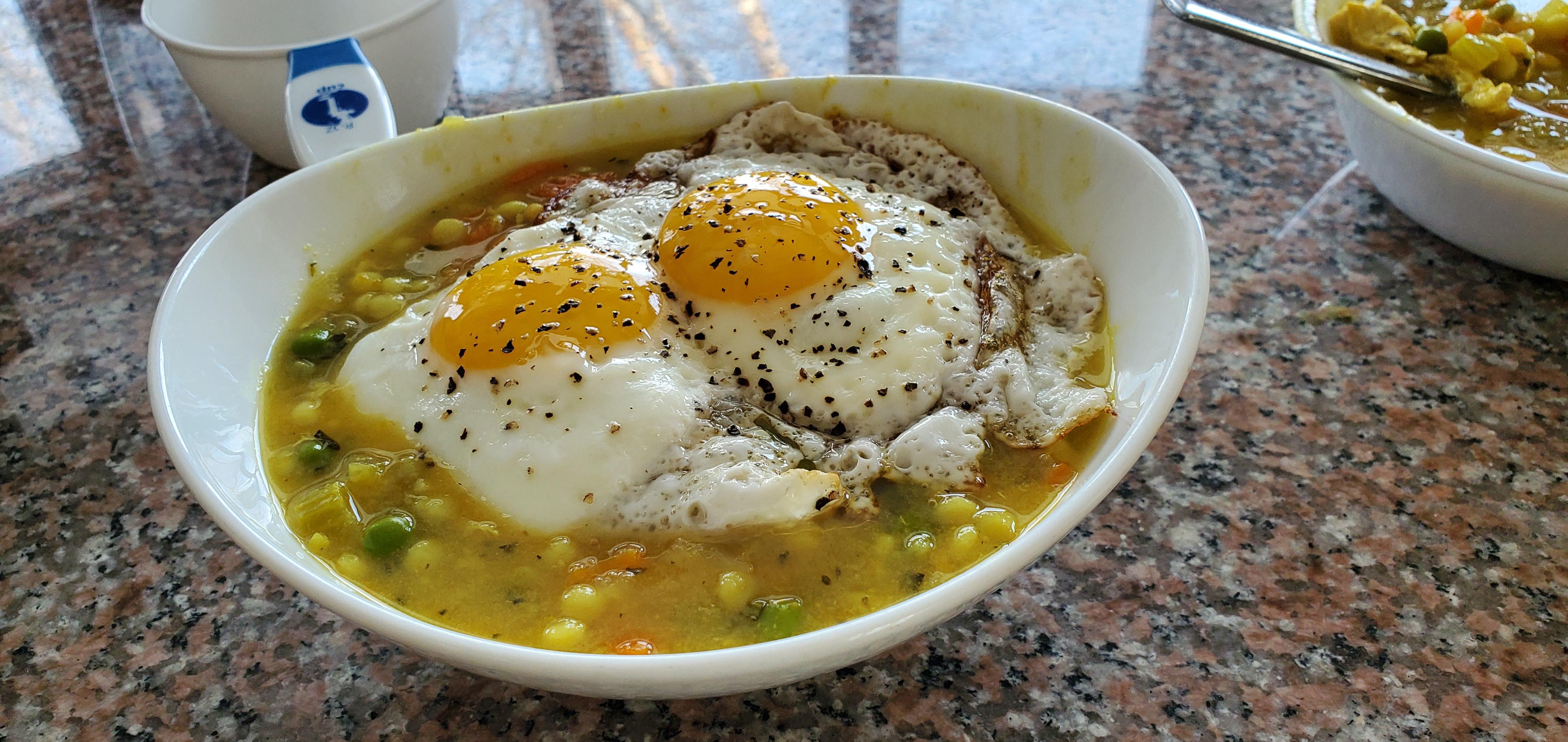 Chicken and pearl pasta soup with two duck fat fried eggs r/PutAnEggOnIt