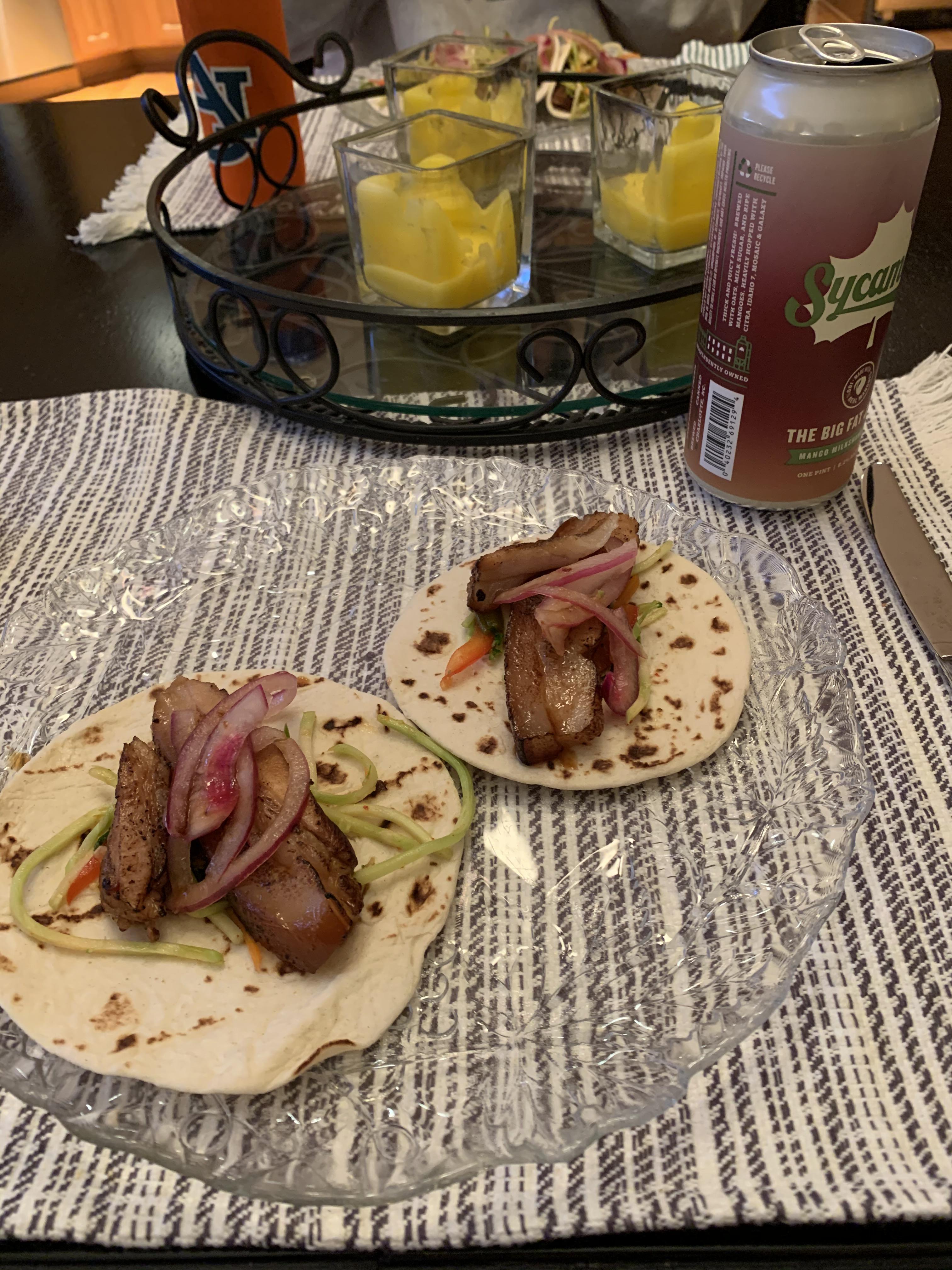 Sous vide Korean pork belly tacos with kimchi slaw and pickled onions
