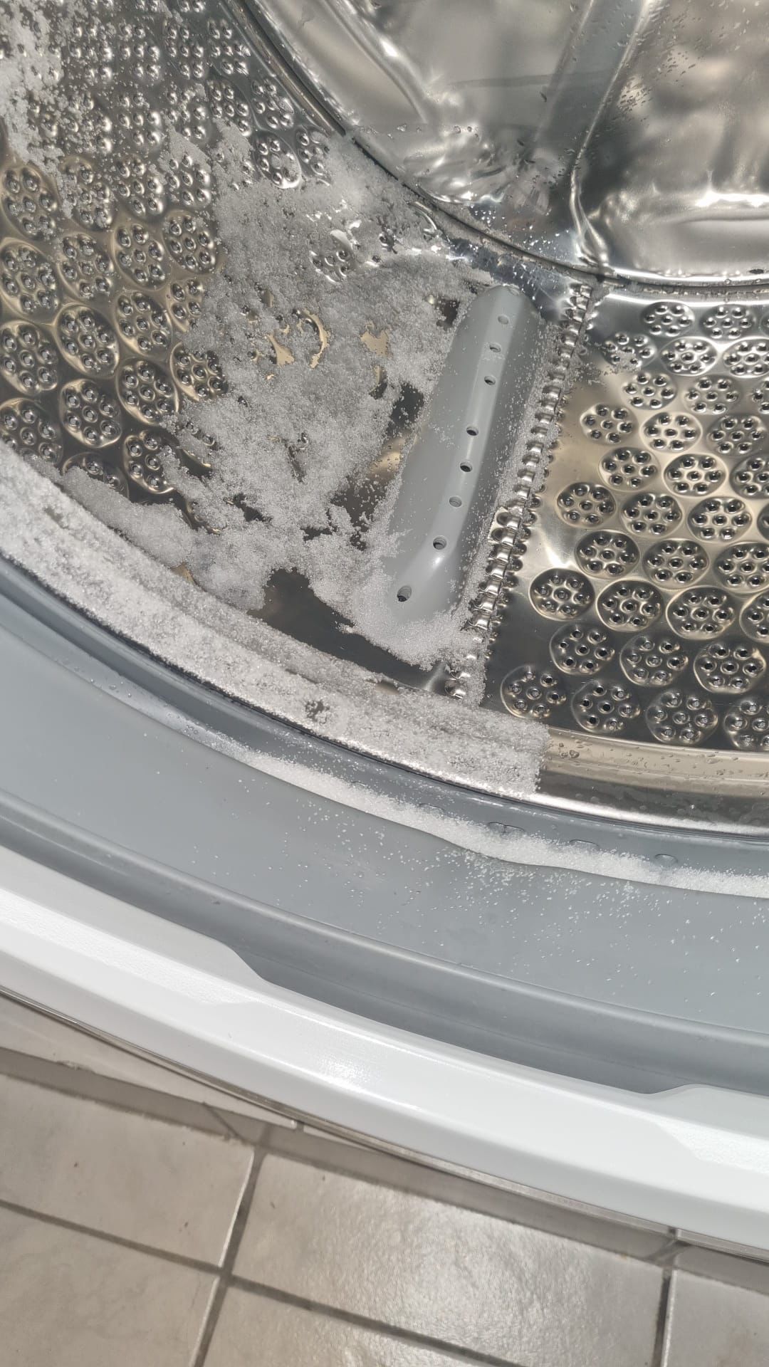 what is this white "sand" that has appeared in my washer dryer since it
