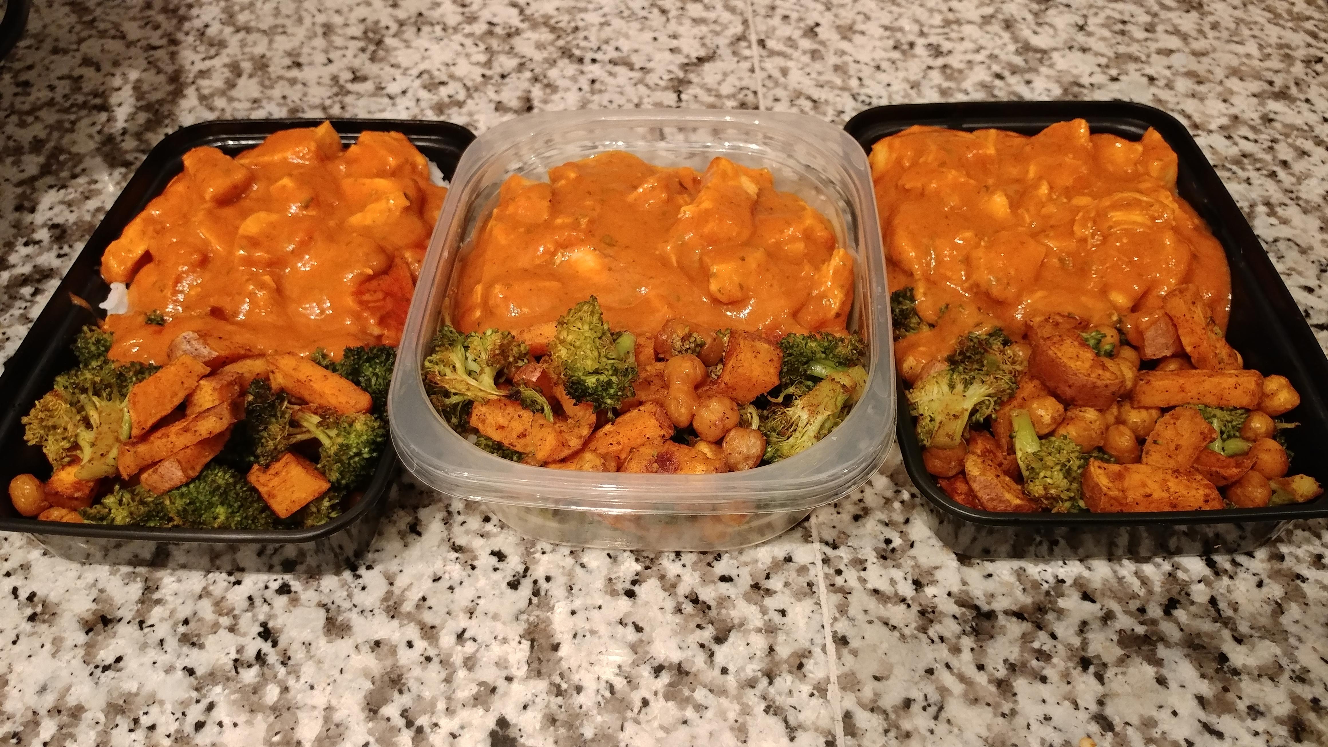 Chicken tikka masala over rice with roasted broccoli, sweet potato and