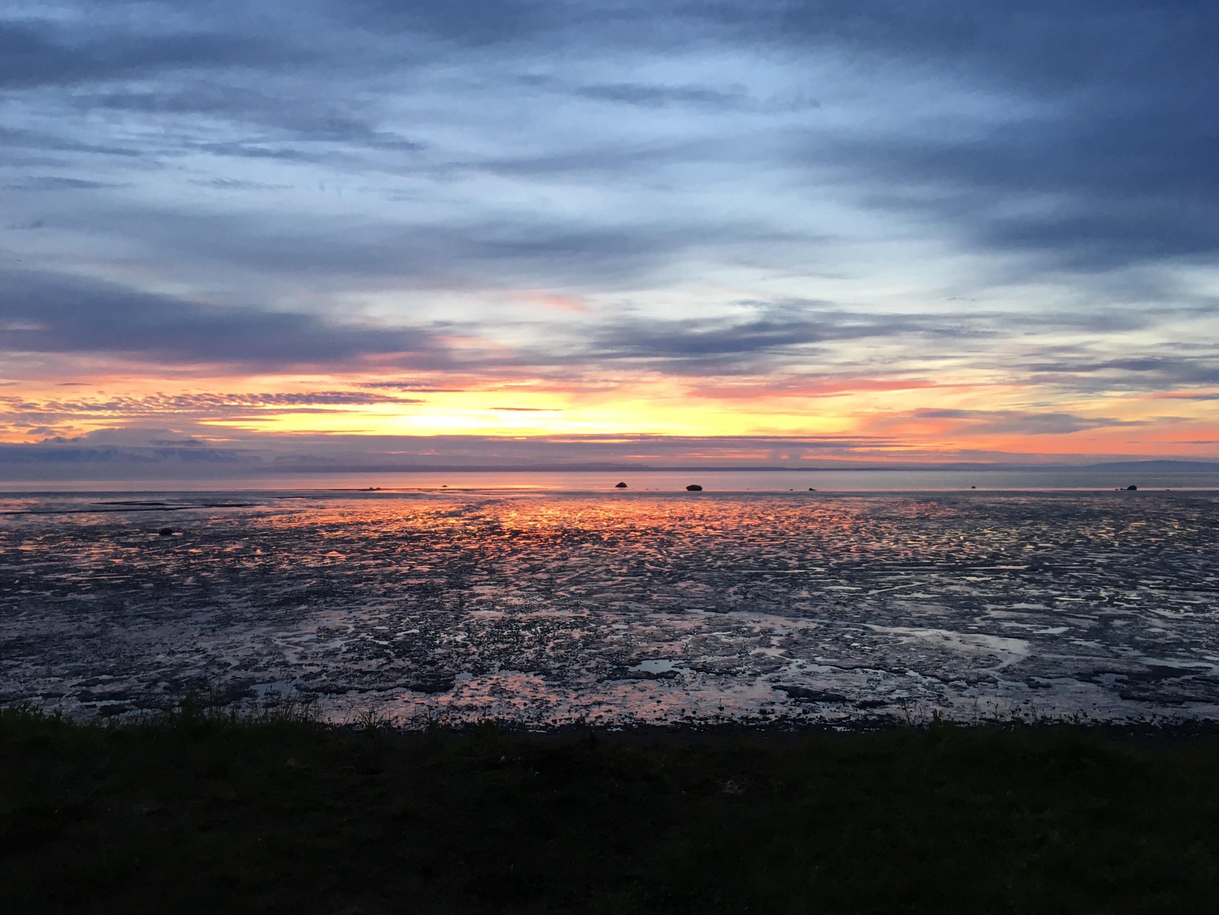 A glimpse of the sun setting over Nikiski, Alaska’s mud flats