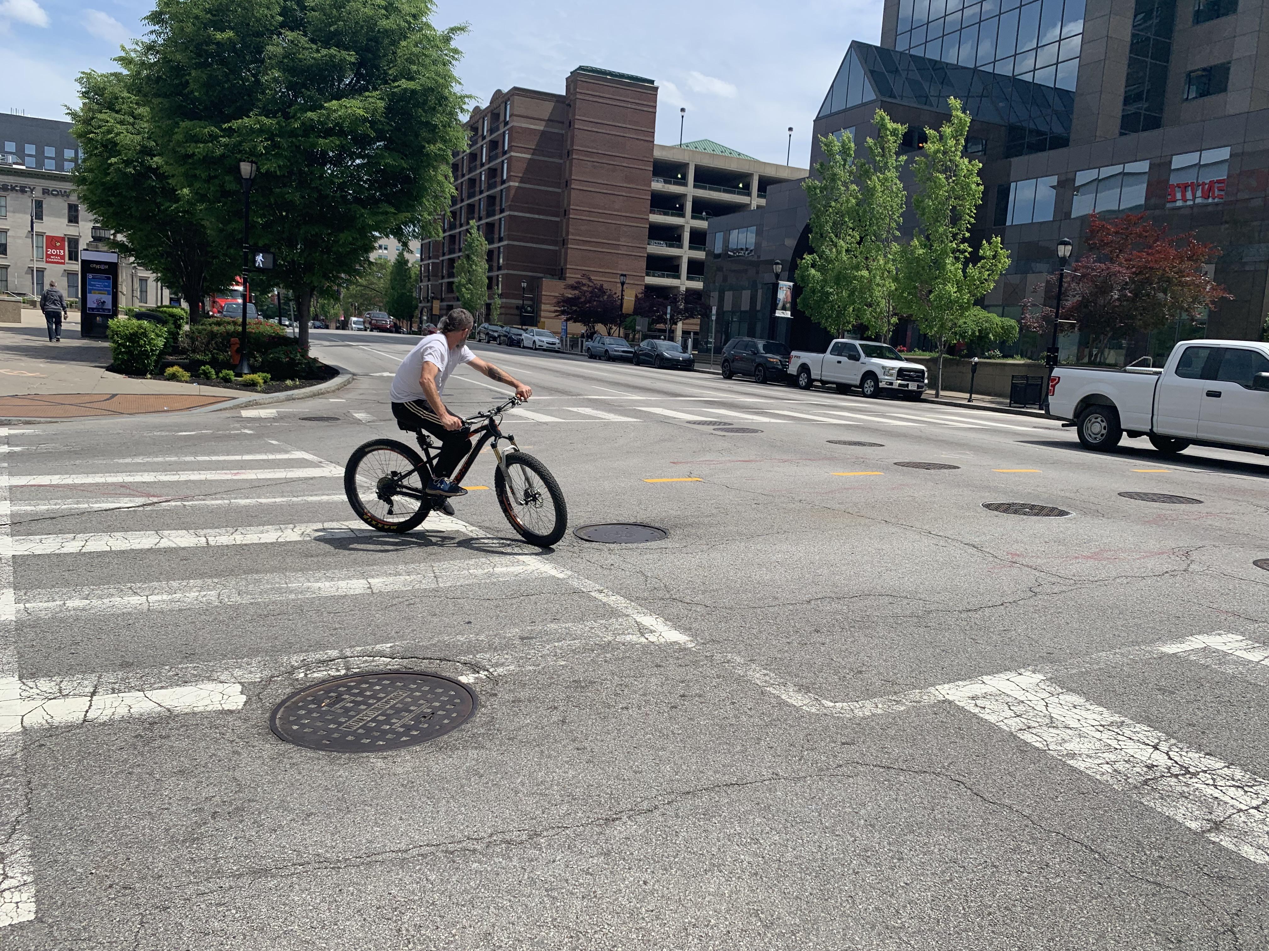 Justin Chancellor riding in downtown Louisville before the show