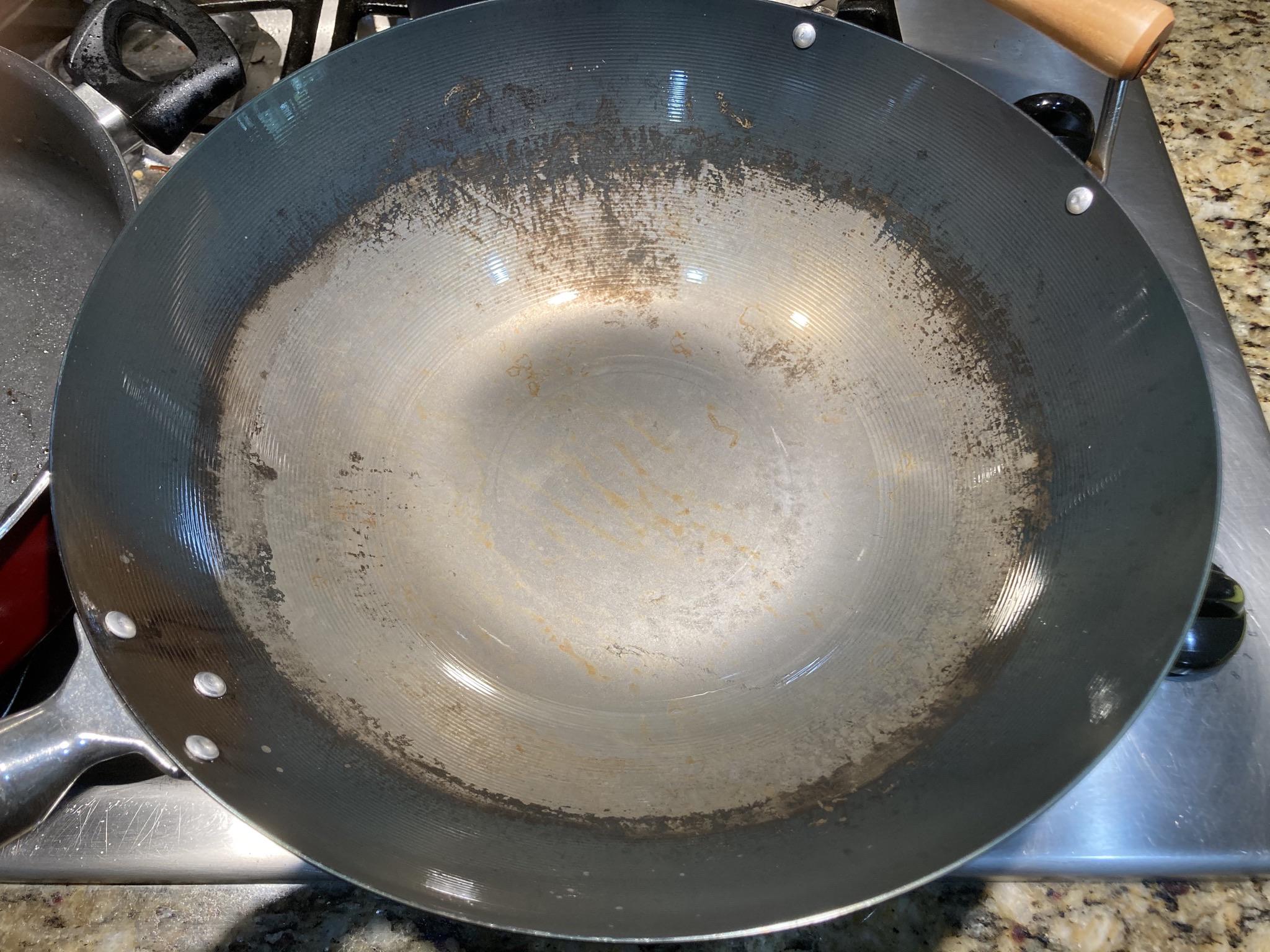 I stir fried sour cabbage in a seasoned steel wok, what happened here