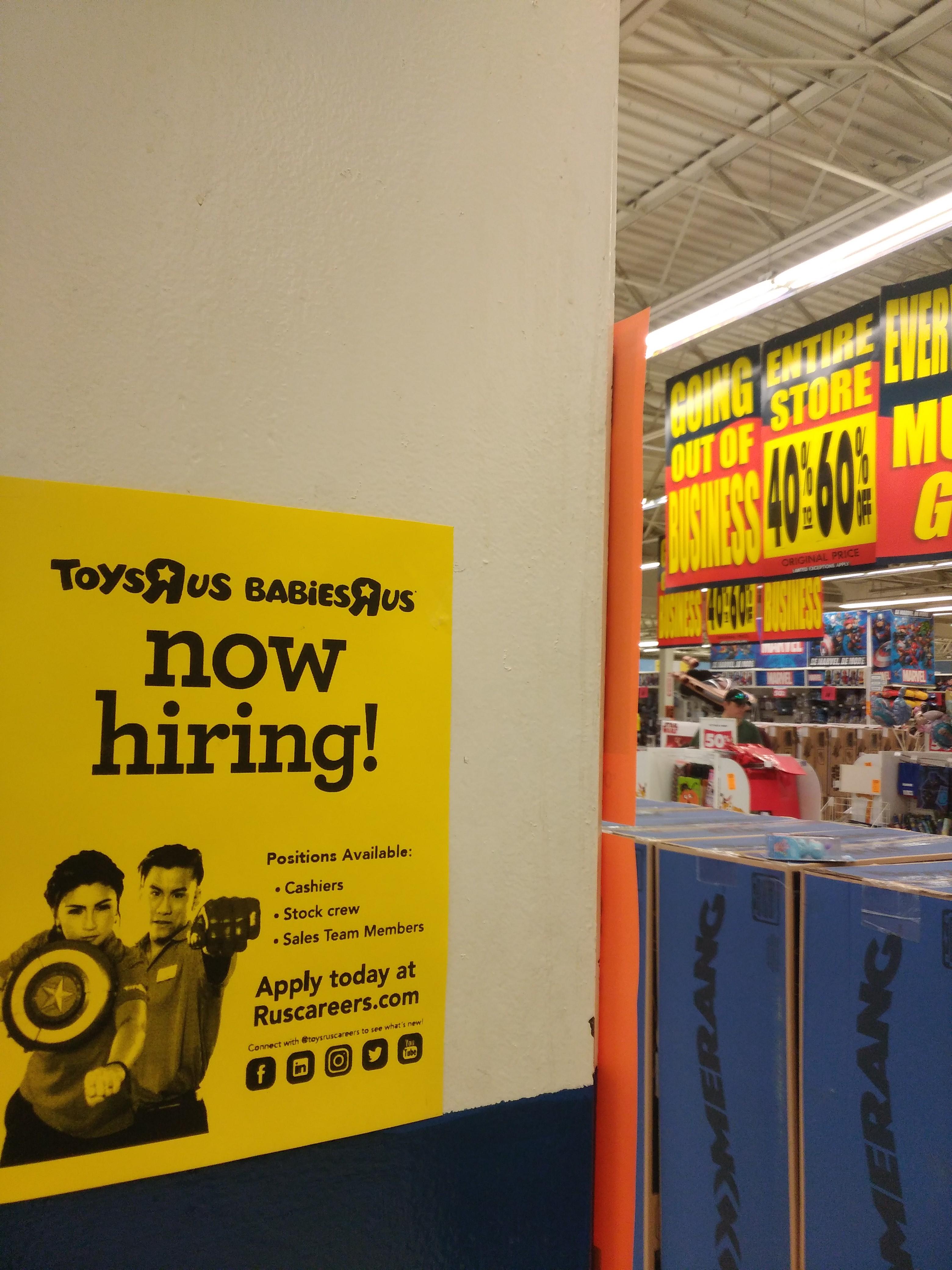 This Toys R Us has a "now hiring" sign during their going out of
