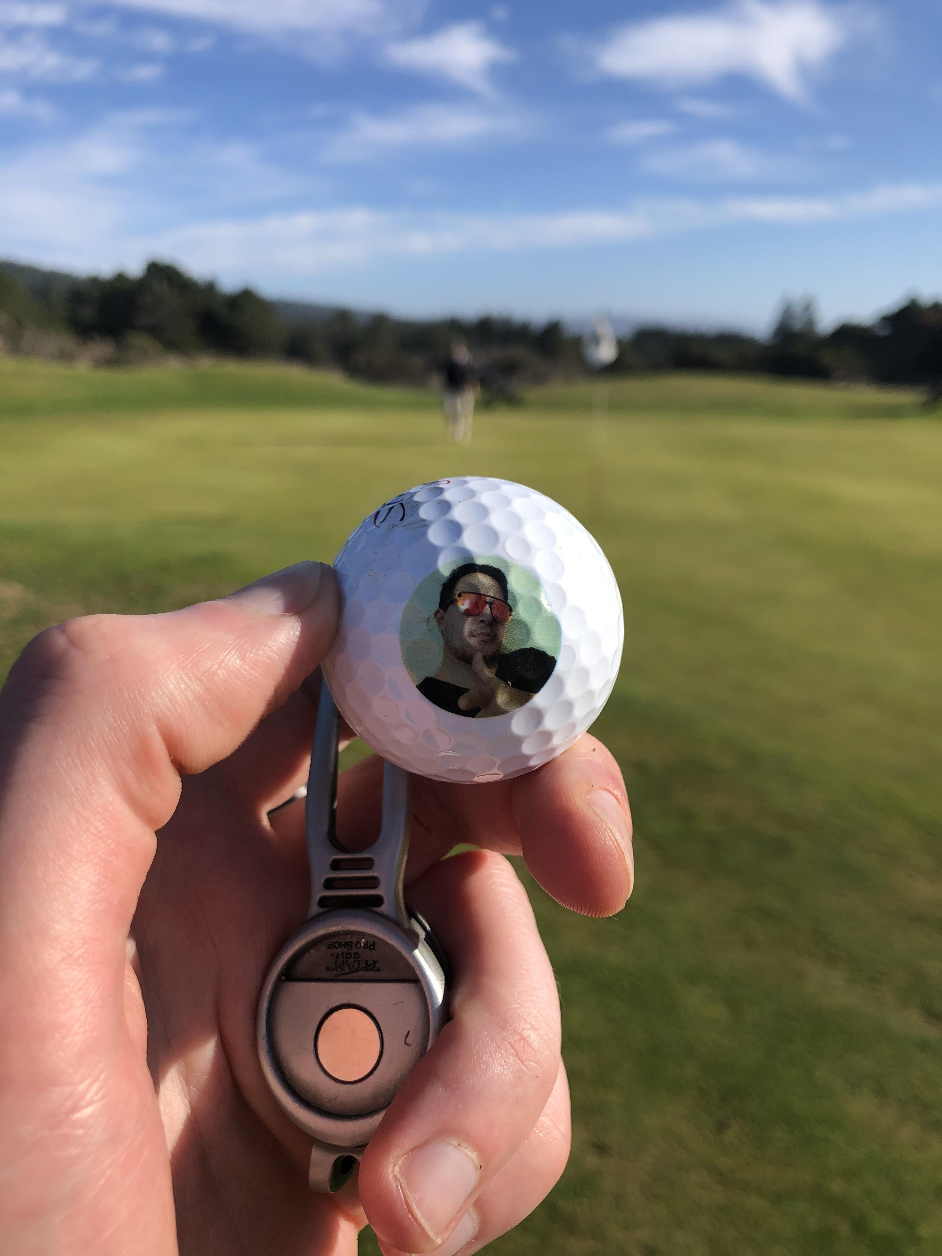 Secret santa sent personalized golf balls with a picture of his face