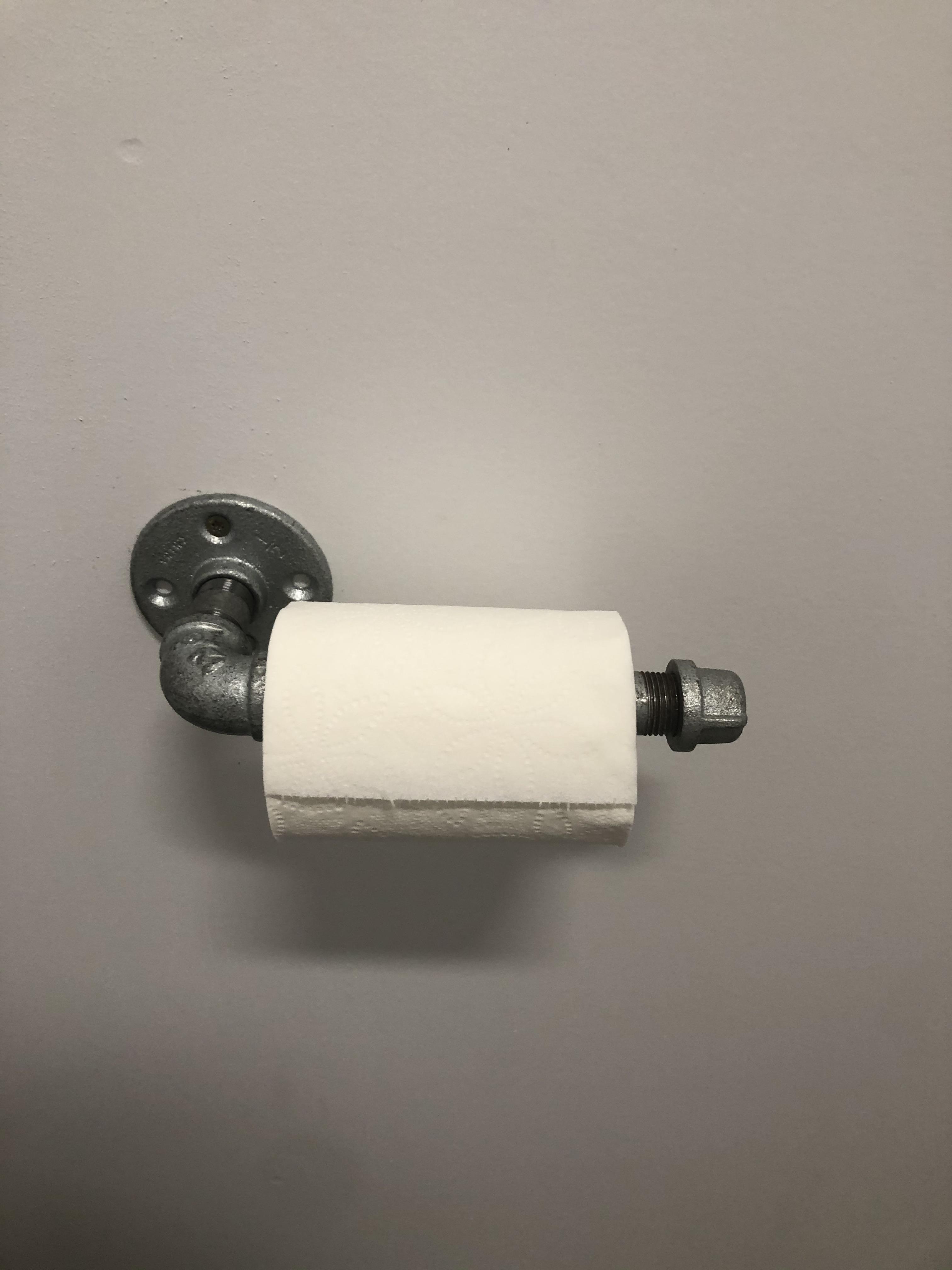 This toilet paper holder made out of plumbing is pretty