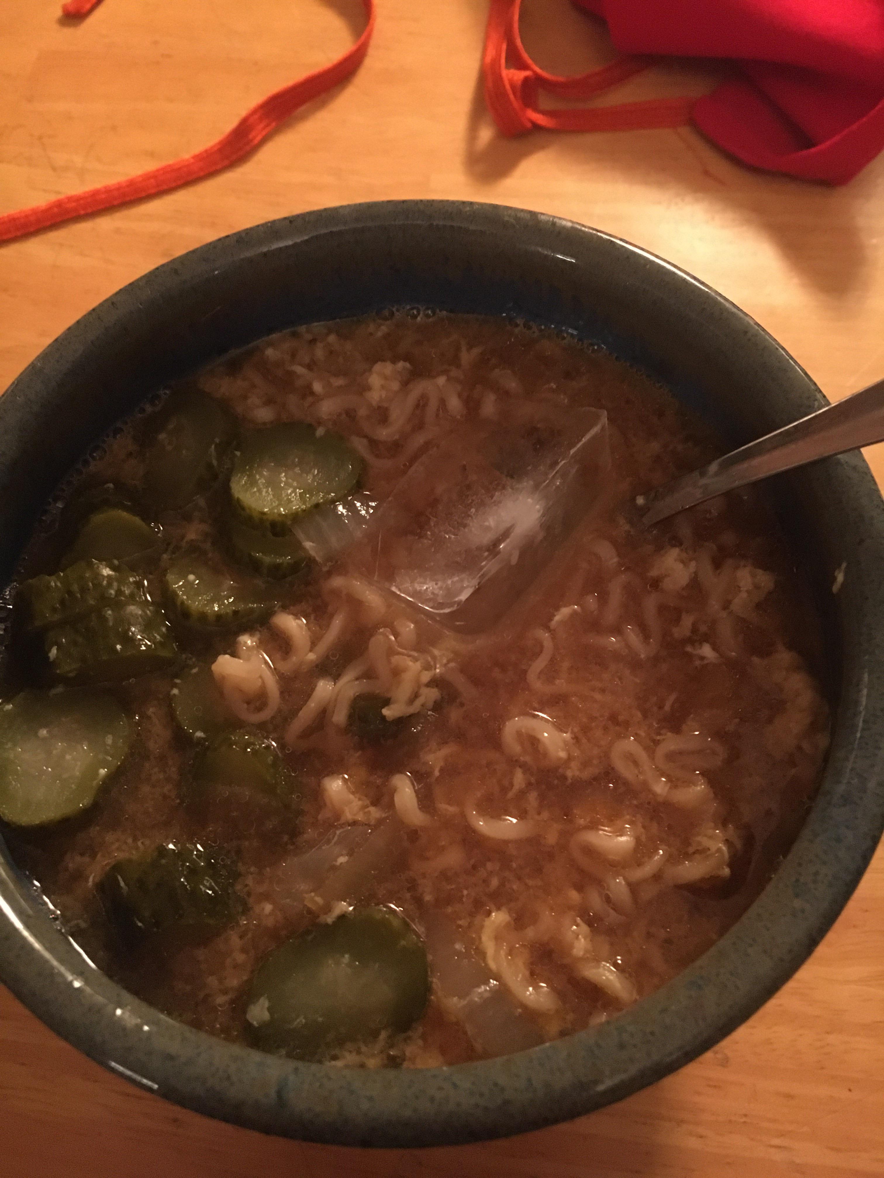 Pickle slice and onion ramen with an ice cube to cool it down from