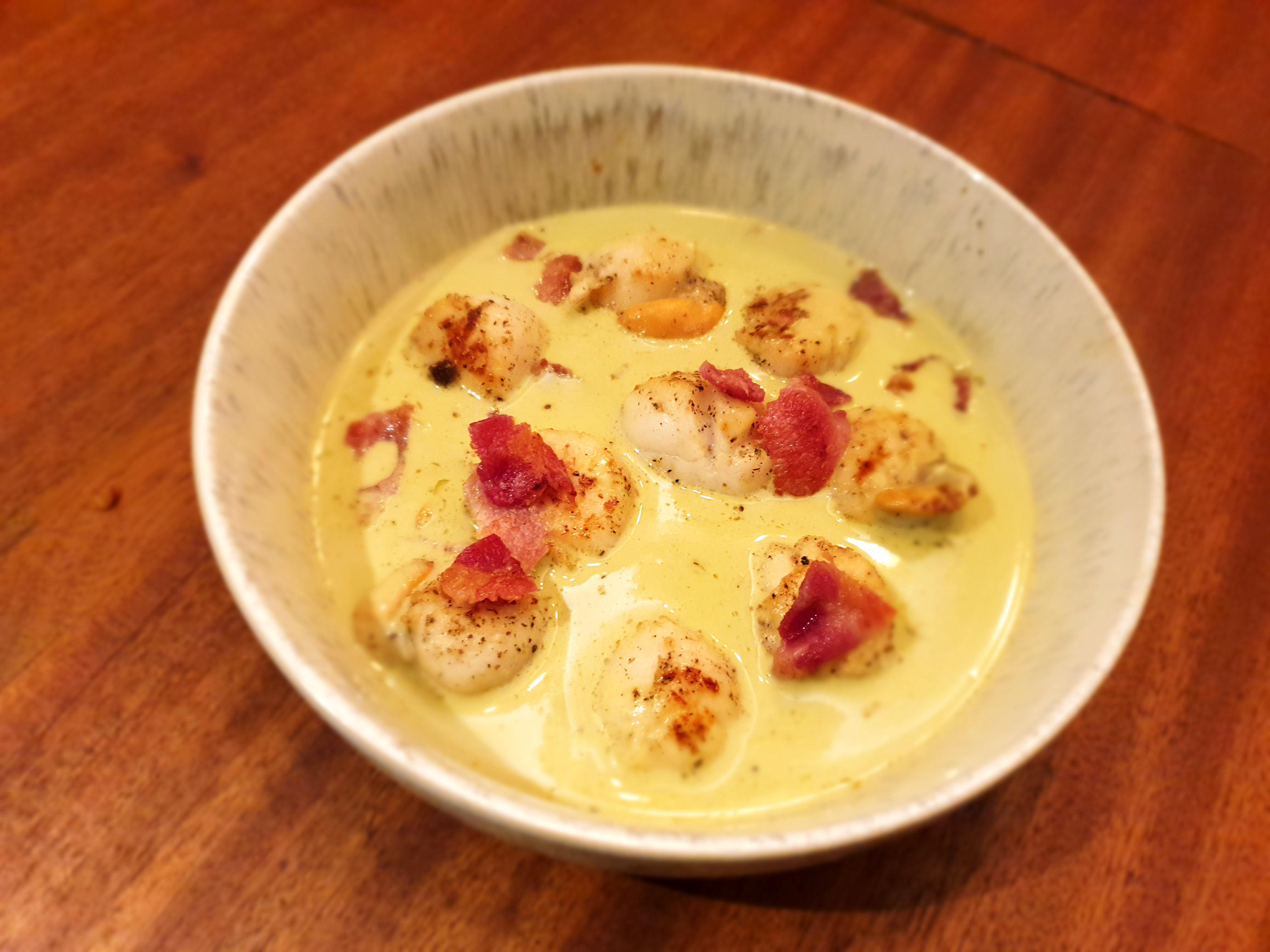 Seared scallops in a broccoli cheese sauce with bacon sprinkles. "Keto