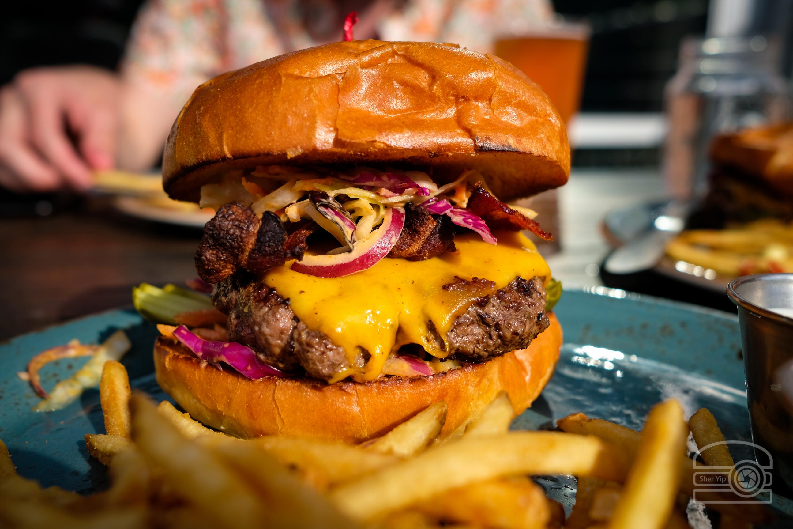 Burger w/ Sriracha Slaw, Cheddar, Bacon, and Slabs of Pickles Table 9