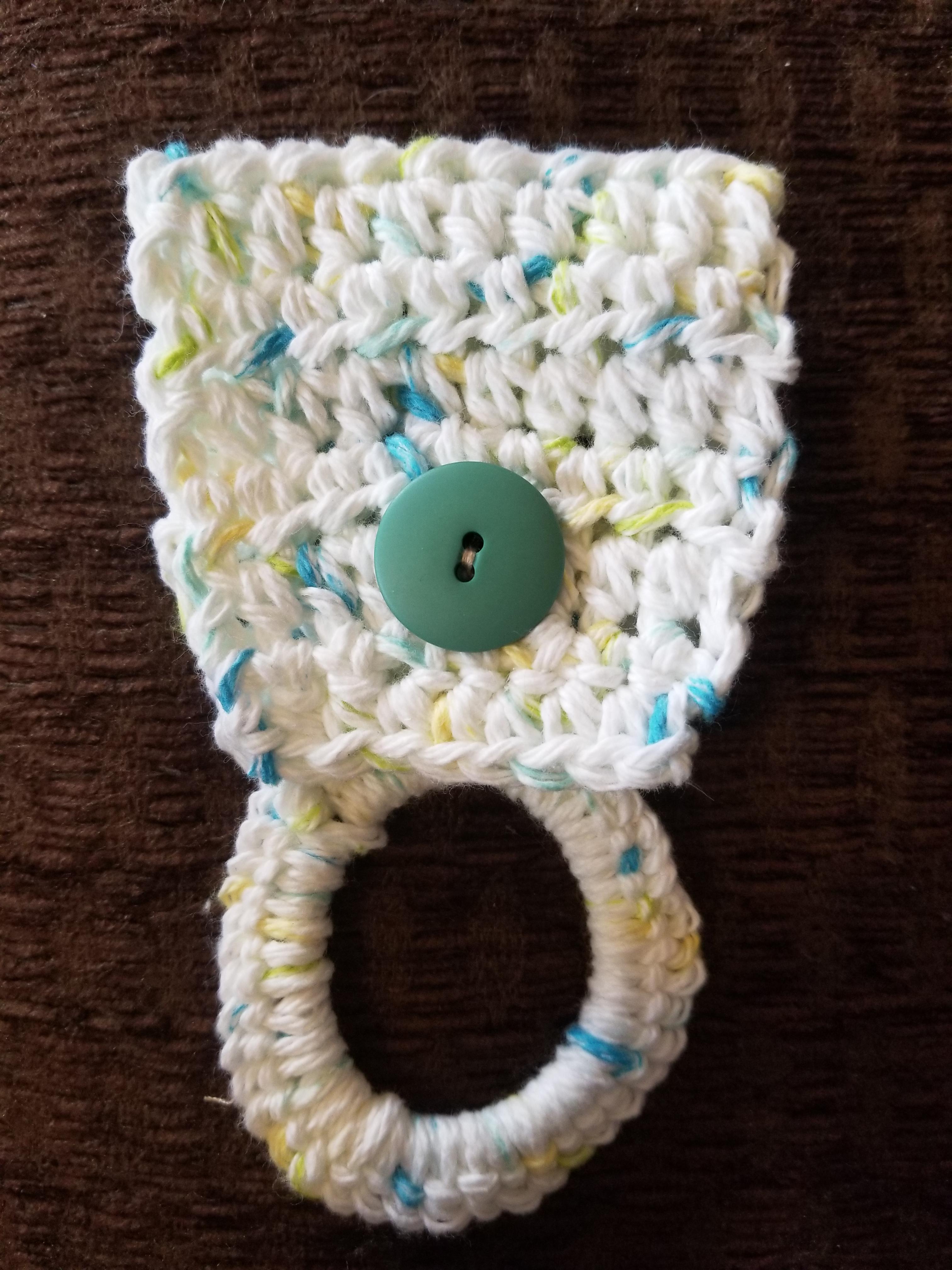 Made a tea towel holder. The ring is a hair elastic so holds the towels