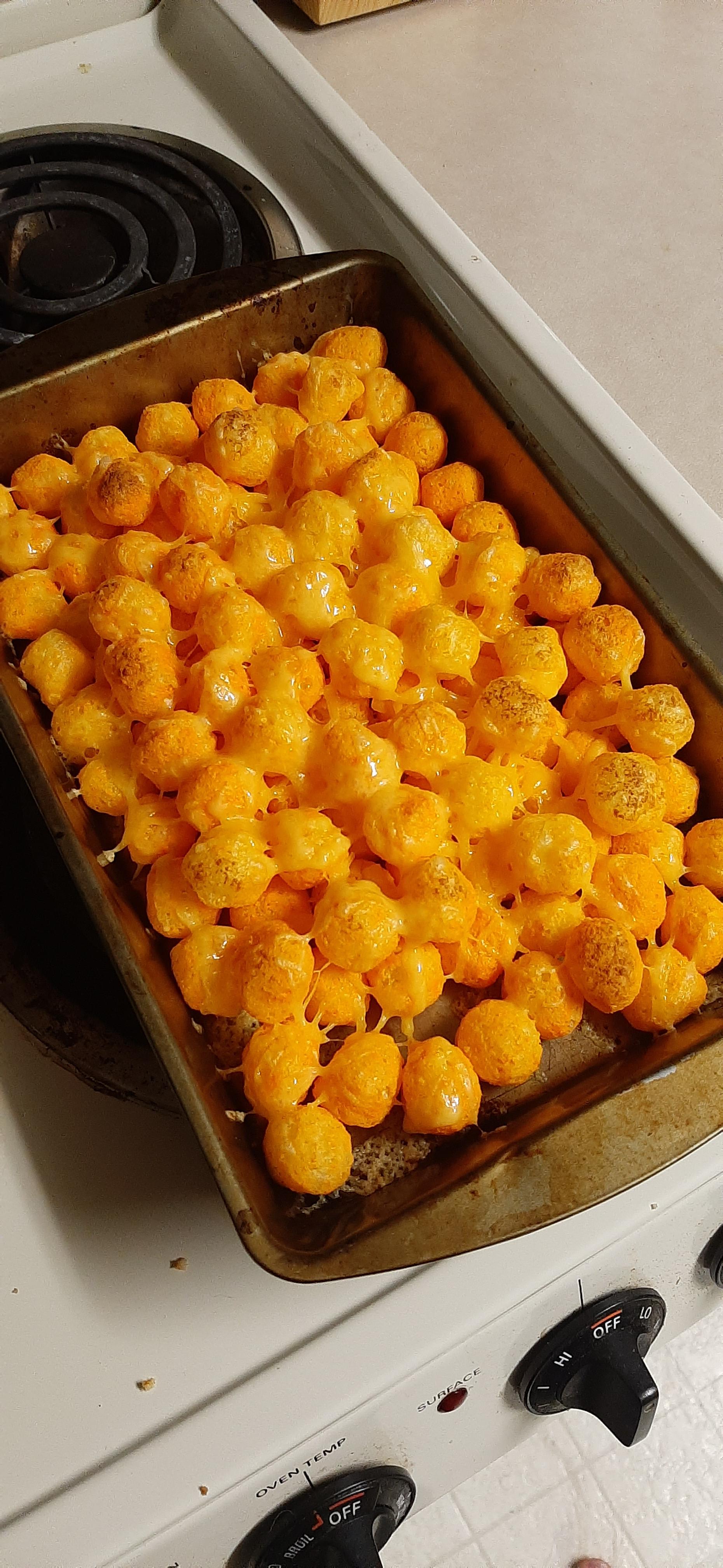 Baked cheese balls, topped with extra sharp cheddar cheese r