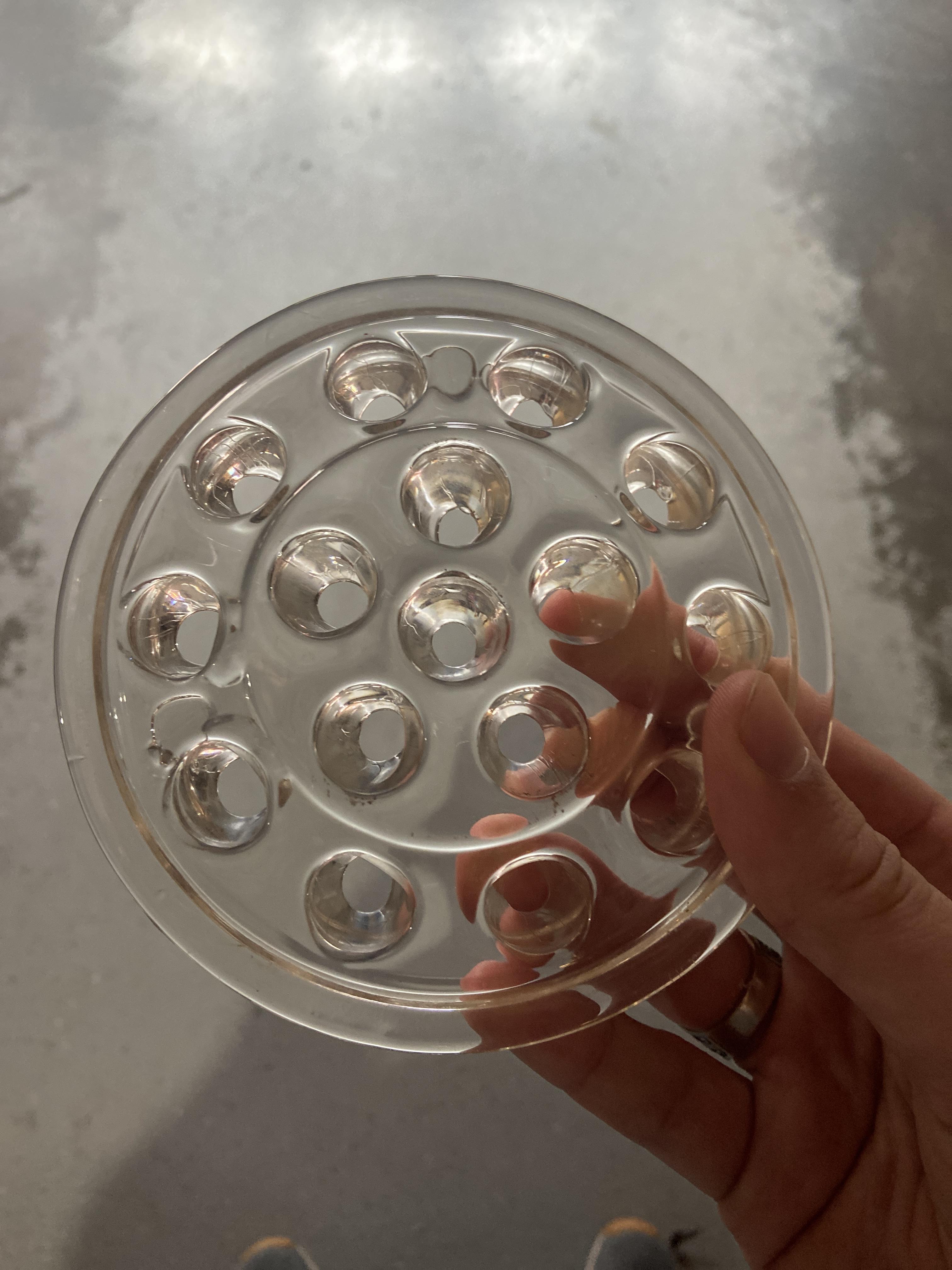 Found an odd circular piece of glass with holes around it. Any idea