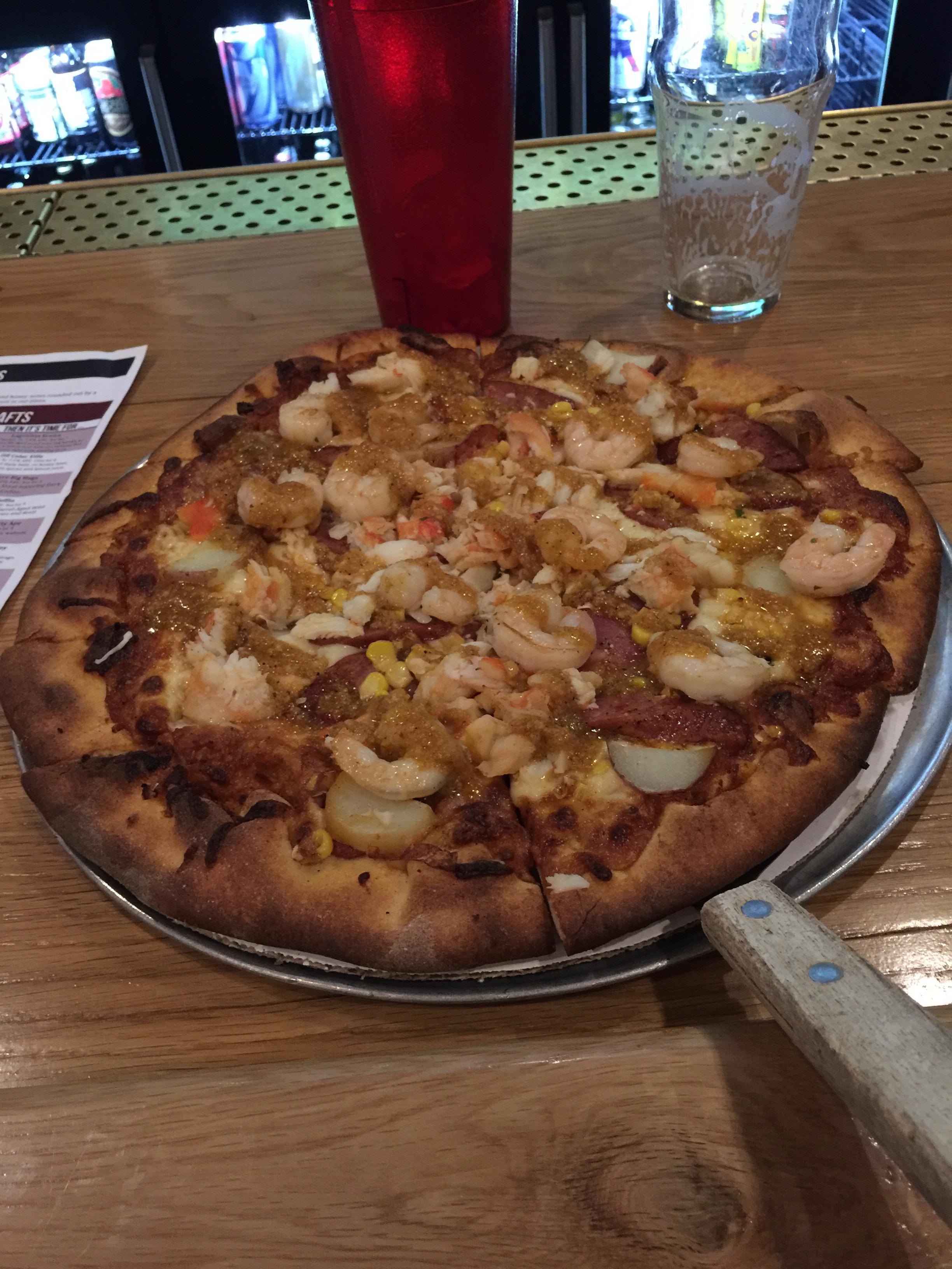 [I Ate] pizza topped with king crab, garlic shrimp, andouille sausage