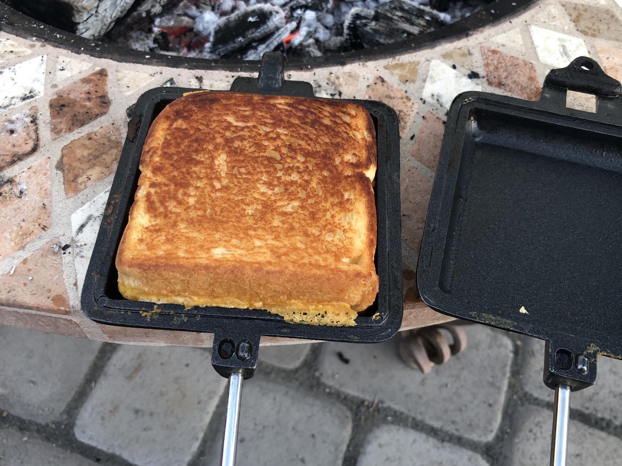 Grilled cheese made in a campfire with a pie iron. r/grilledcheese