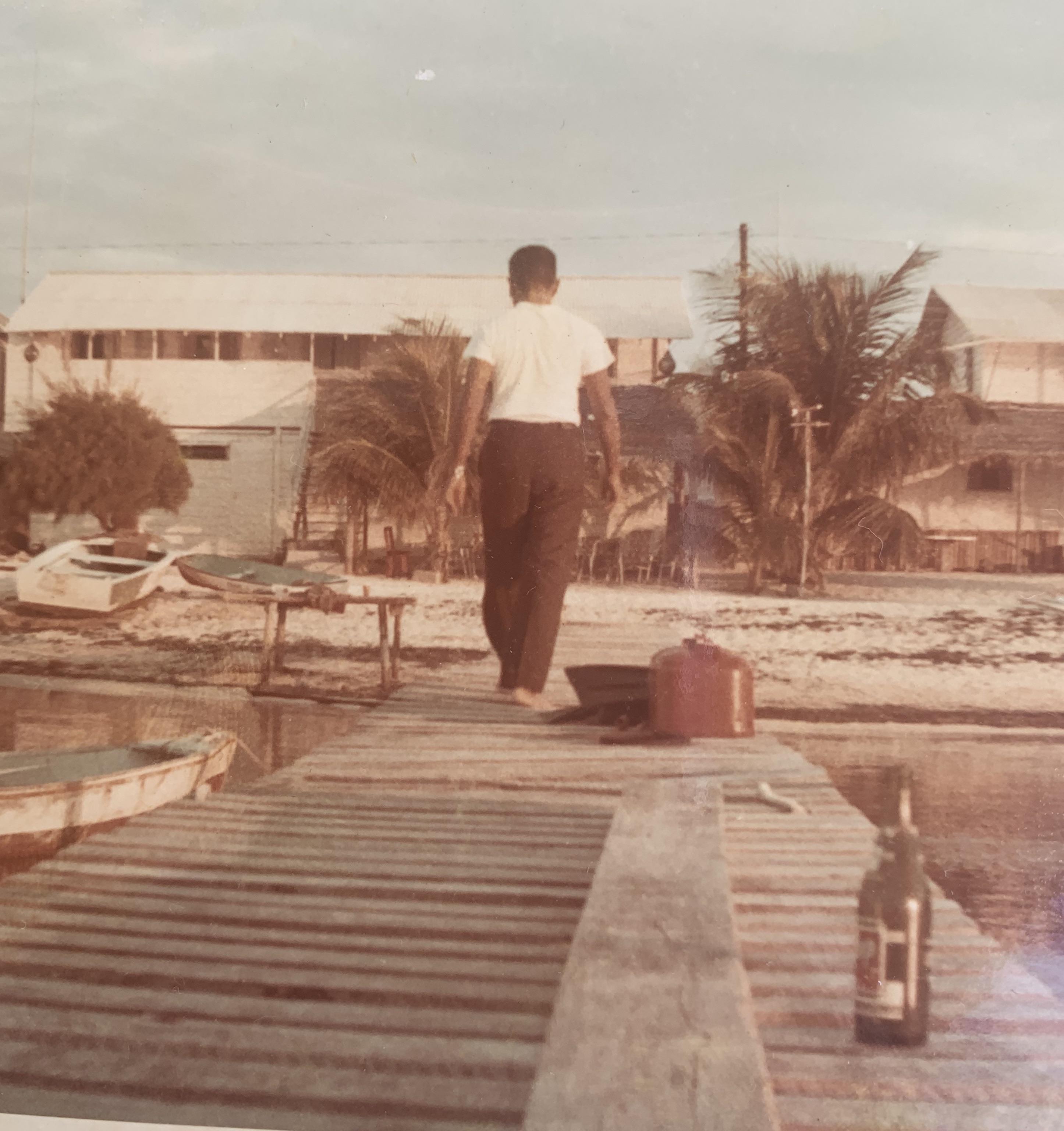 My grandfather walking on a pier in San Pedro, Belize in the late 1960s