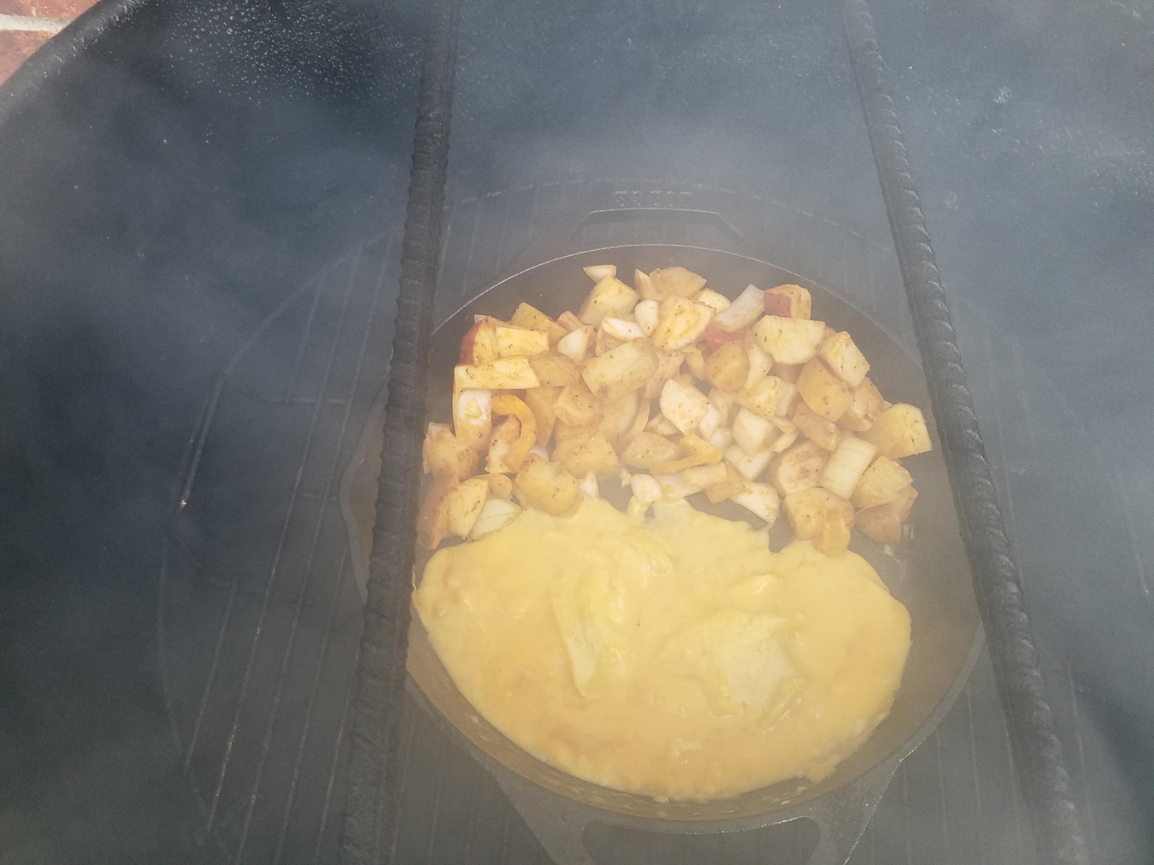 Trying out eggs and potatoes in a cast iron pan on the PBC... r/smoking