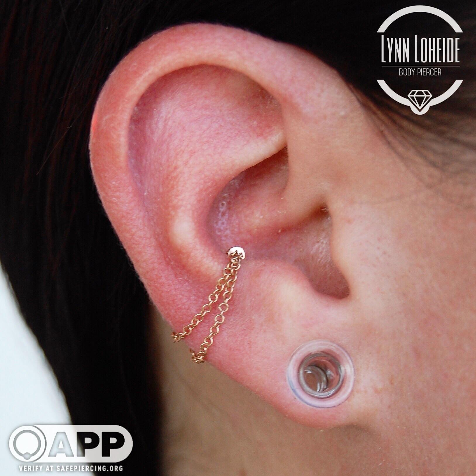 Simple conch piercing upgraded to this custom fitted chain from Maria