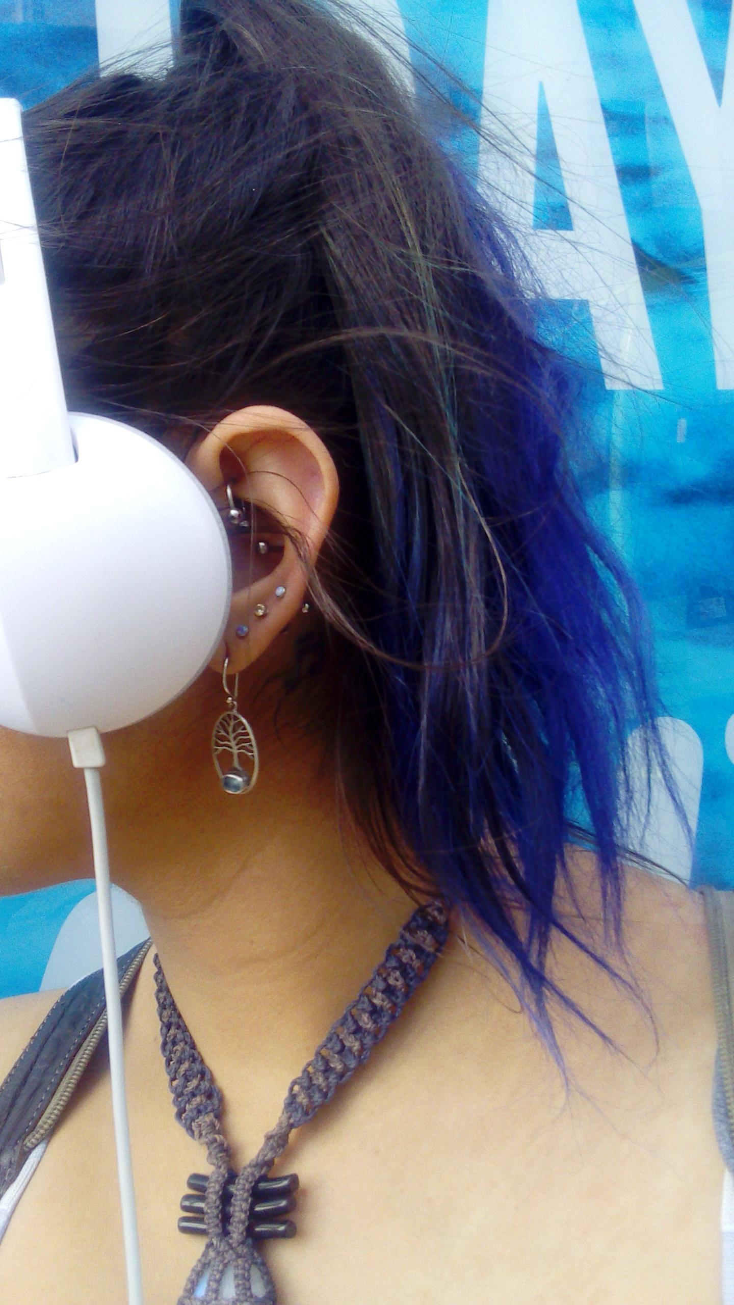 Ahhh the joys of a new ear piercing. Looking like you don't know how to use headphones properly