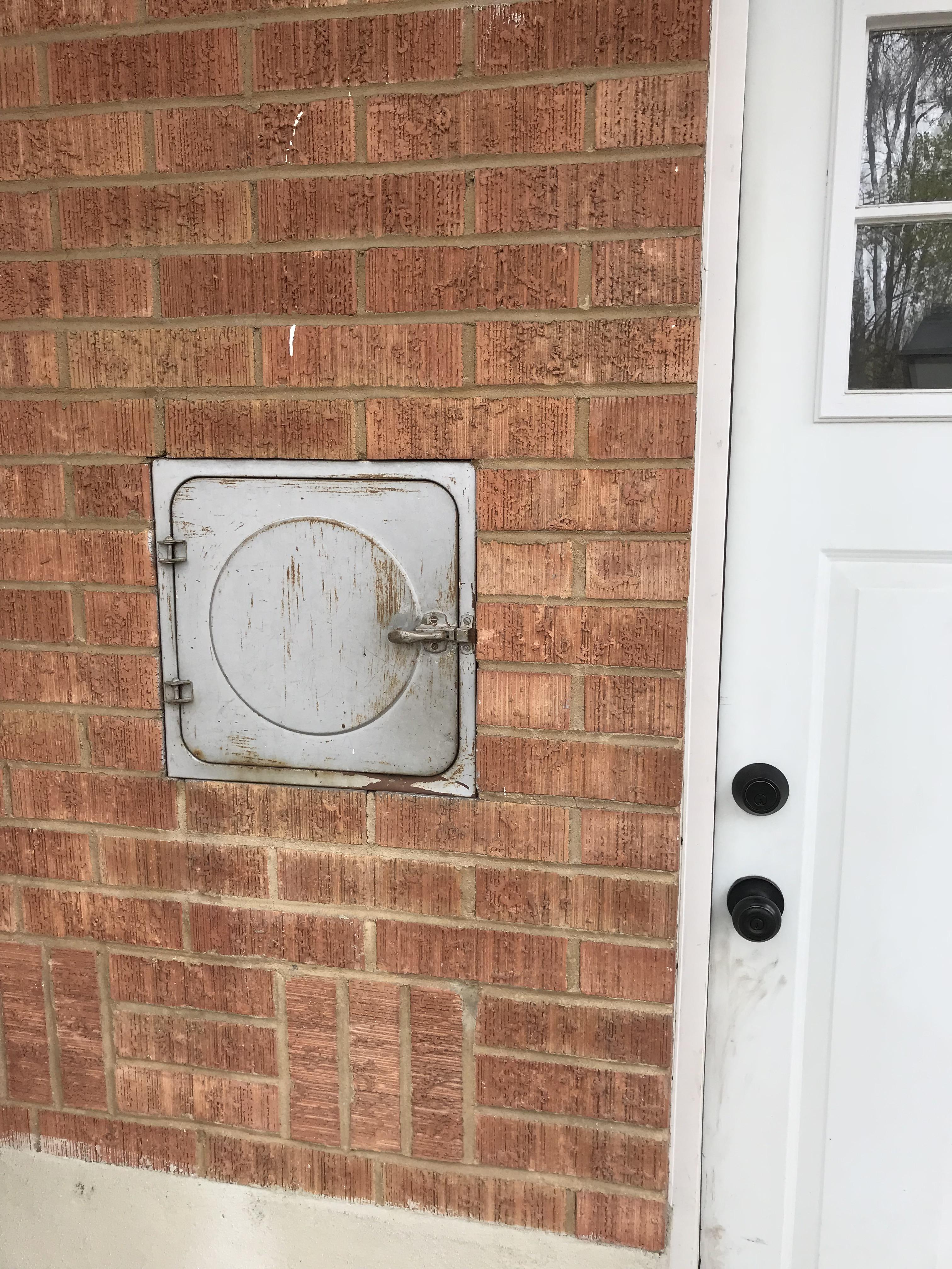 Why is there a trap door near the back door of our house? whatisthisthing