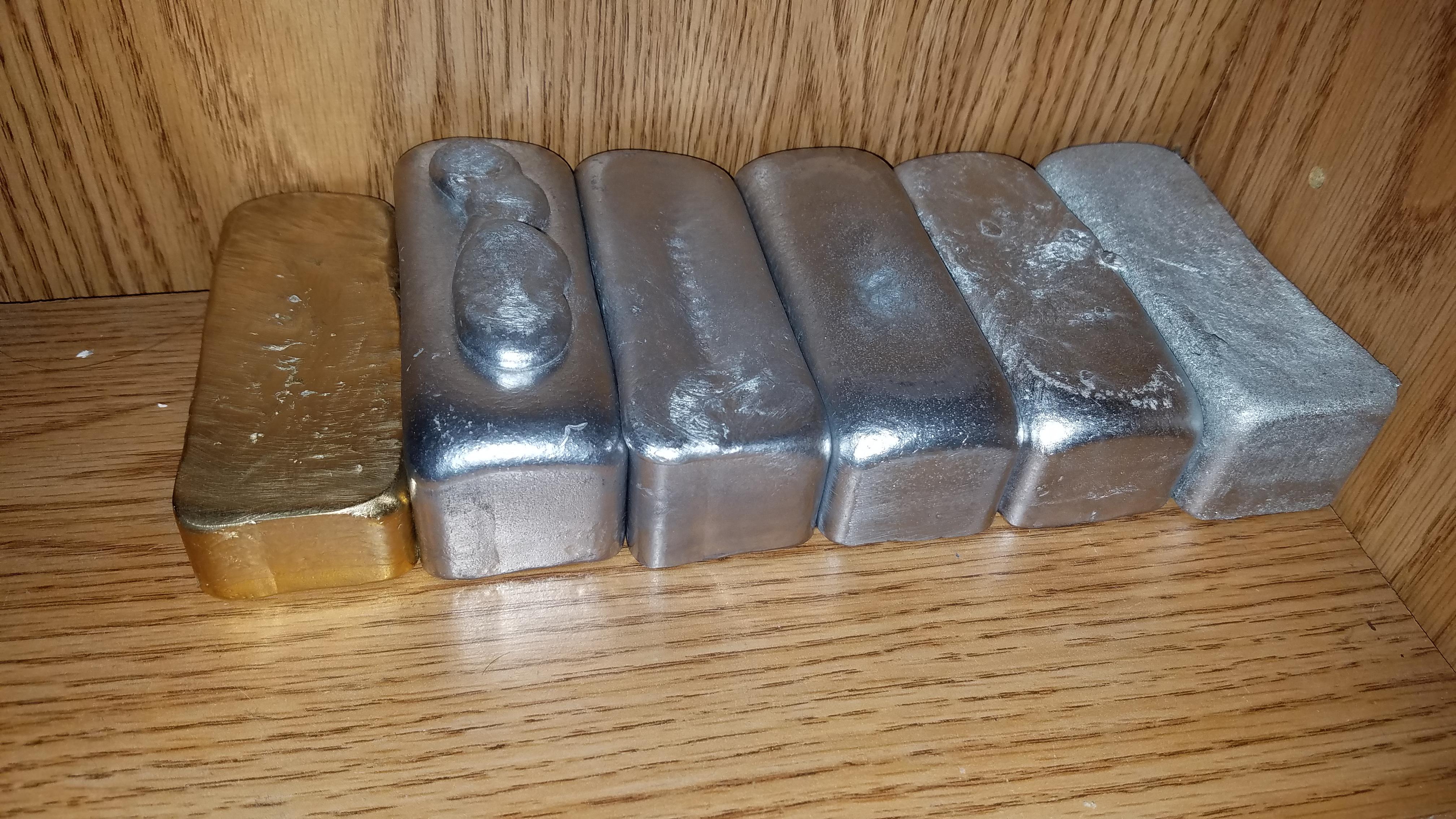 Some of my first ingot casts. All aluminum alloys. Bronze aluminum