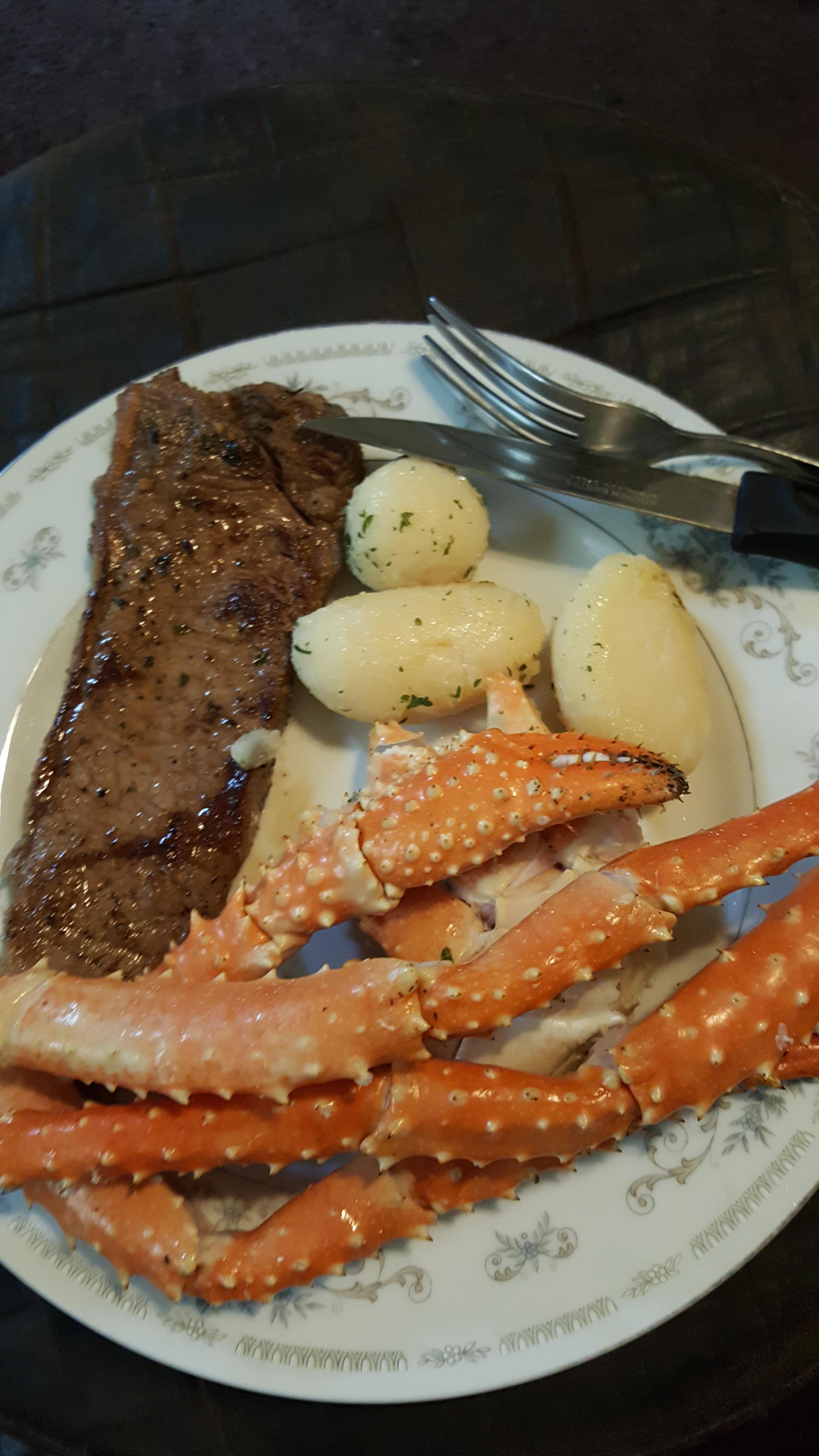 [homemade] New york strip Steak wnd crab legs with potatoes seasoned