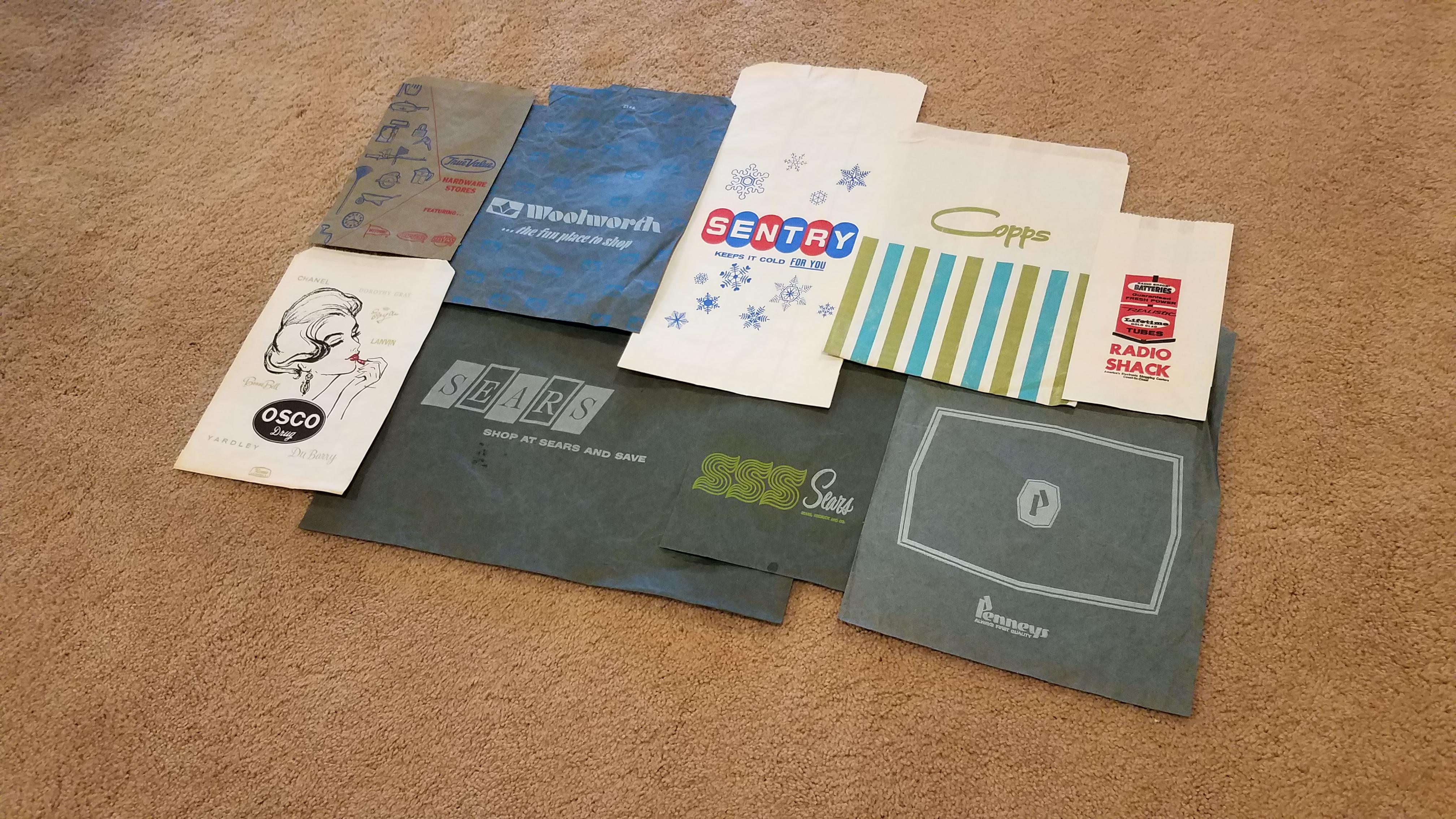 Vintage shopping bags from various retailers, exact dates unknown. r