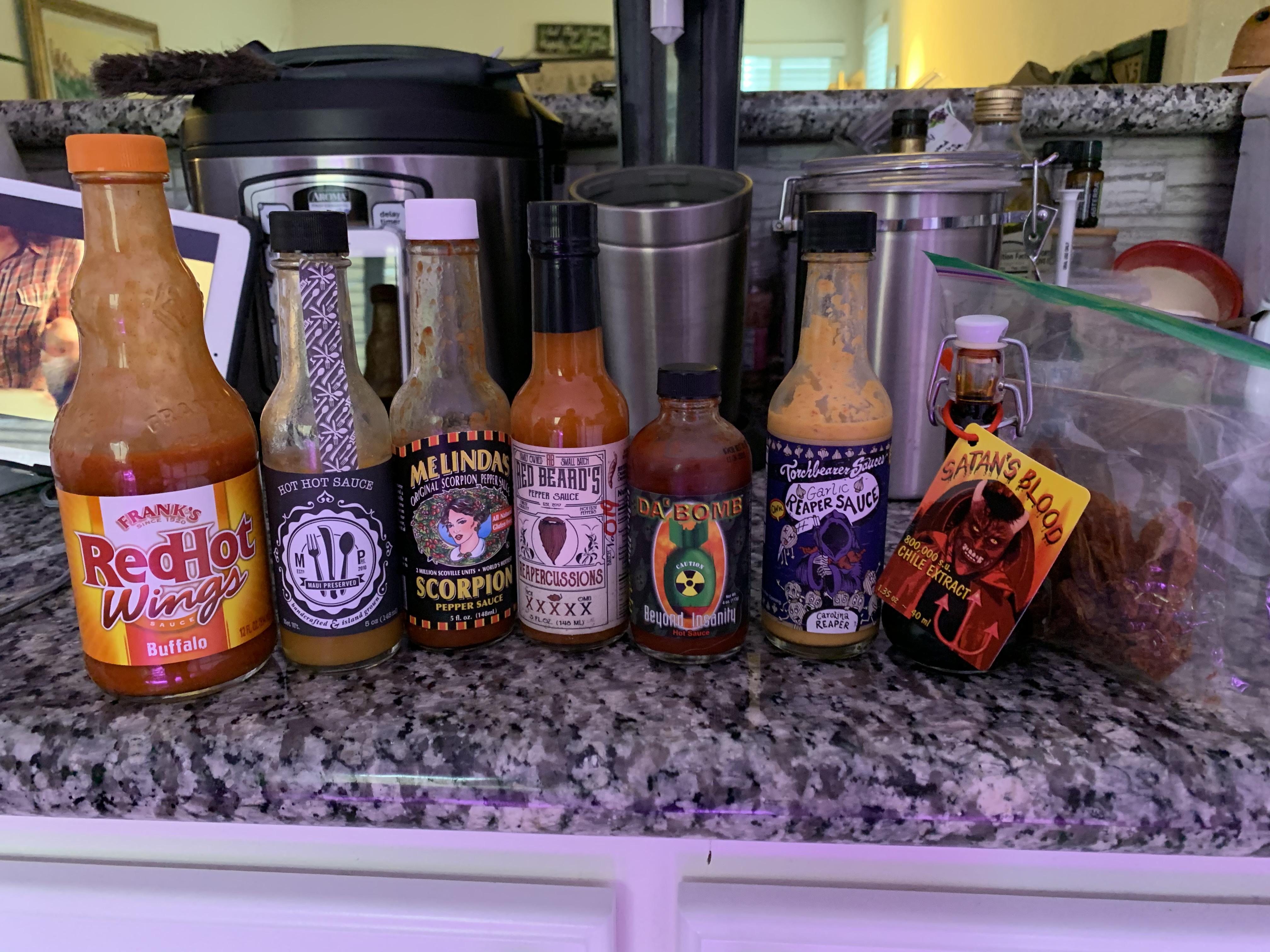 Our super bowl wing challenge sauce lineup, finishing with chocolate bhutlah dust. r/spicy